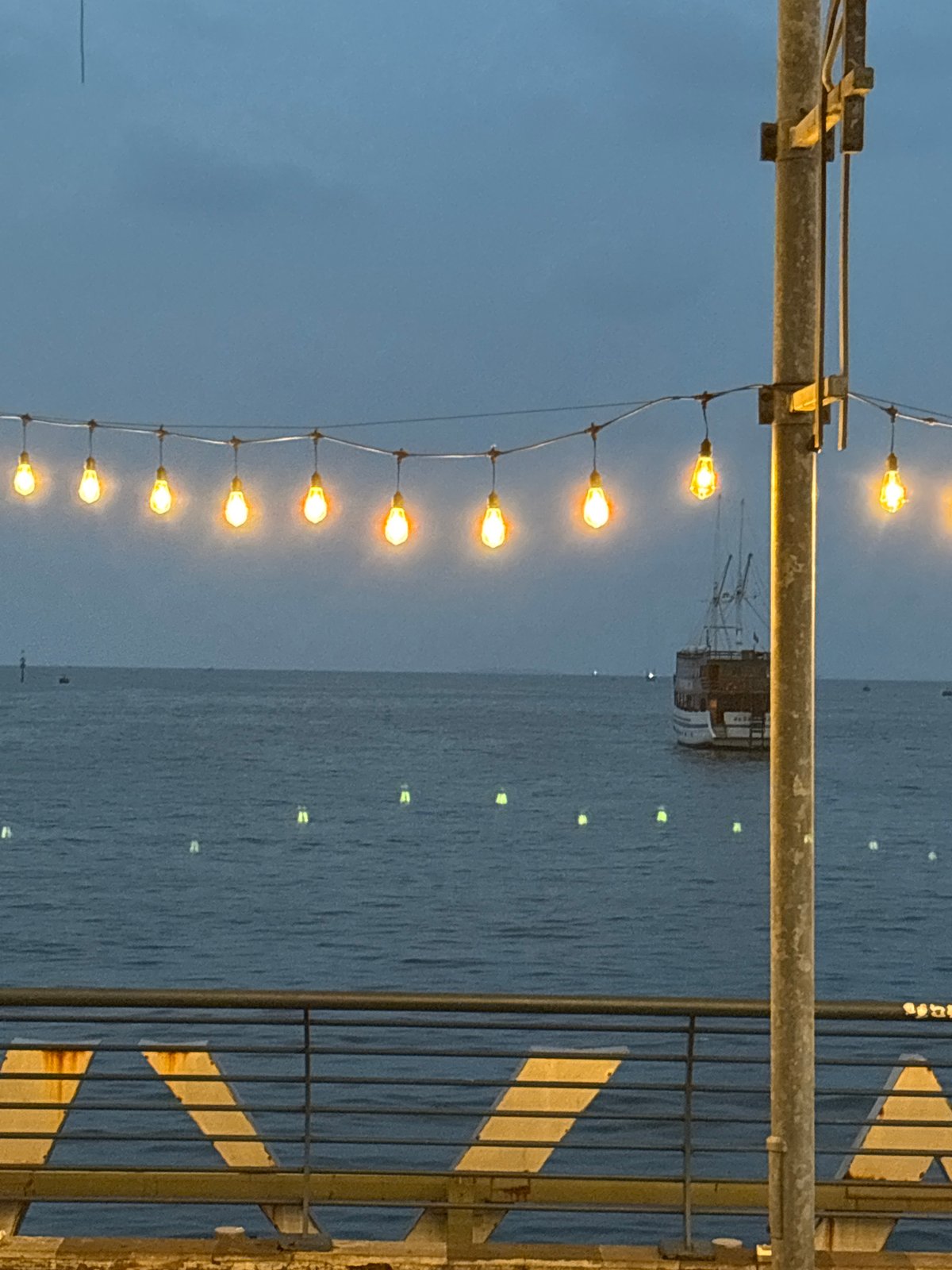 Evening stroll captured on illuminated Jakarta waterfront pier