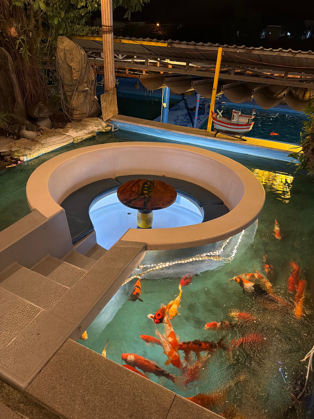 Nighttime restaurant visit with koi pond and helicopter attraction