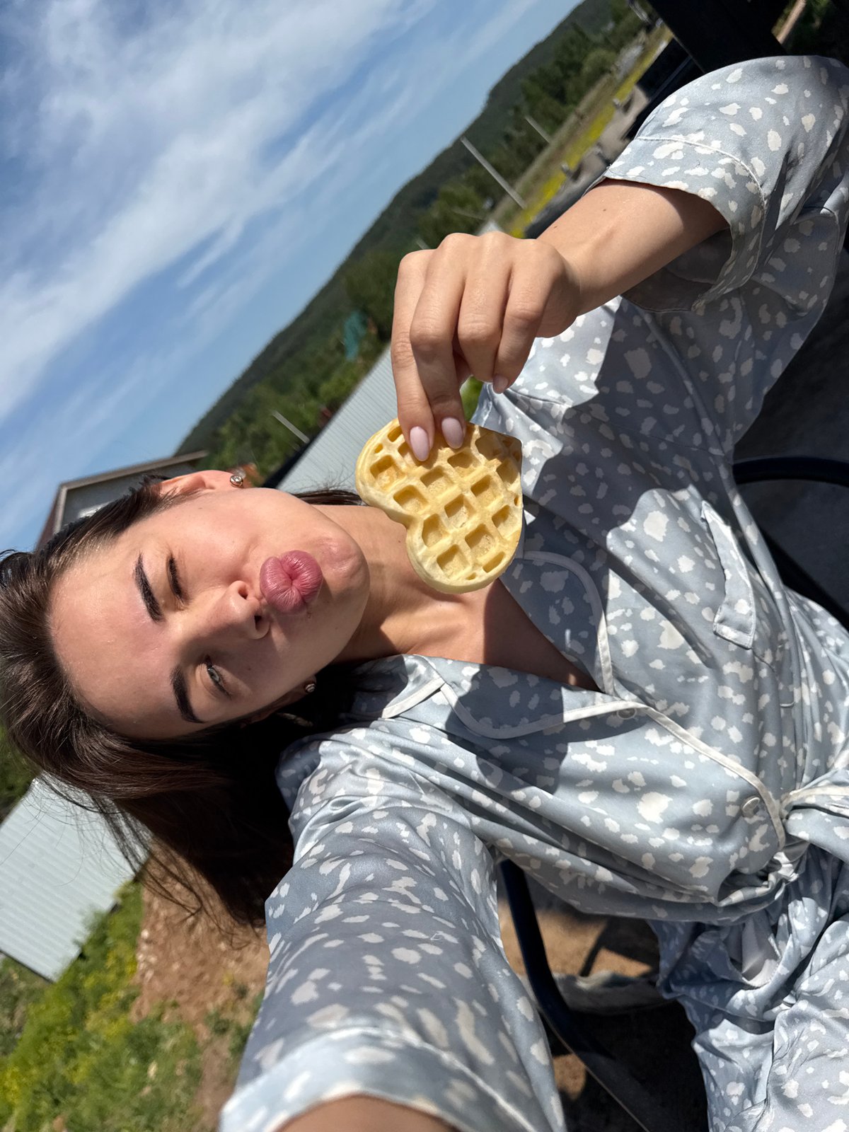 Woman takes waffle selfies during outdoor pajama breakfast