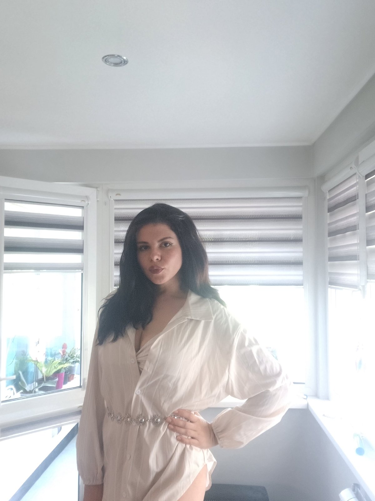 Woman photographed indoors in Sofia apartment near window