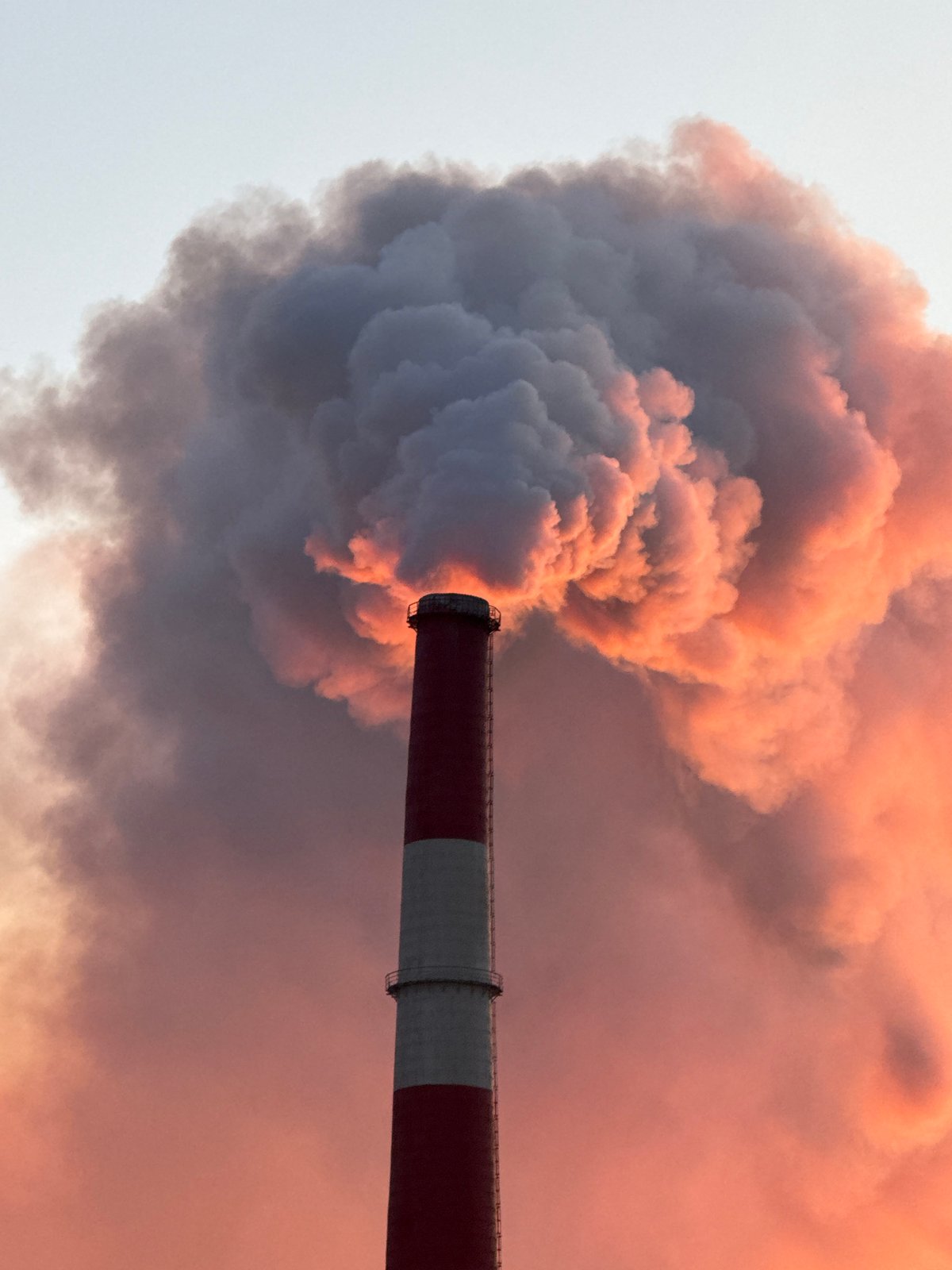 Norilsk smokestack belching smoke at sunset