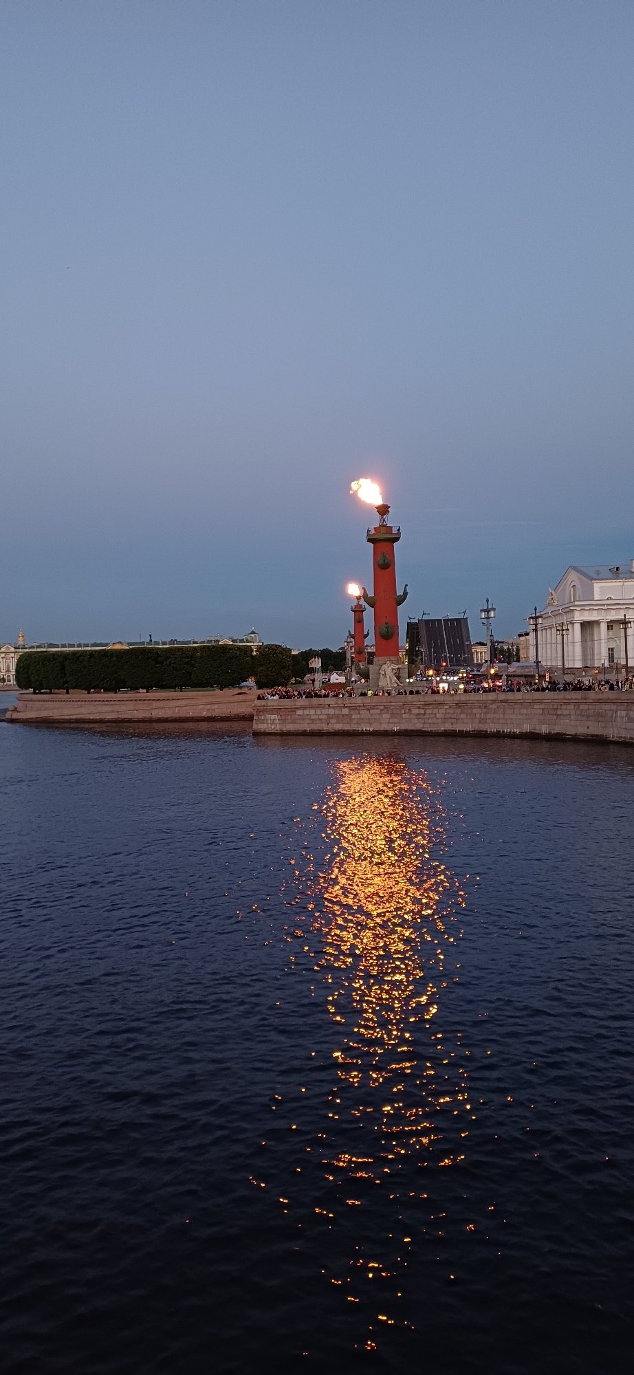 Evening crowds gather as Rostral Columns burn in Saint Petersburg