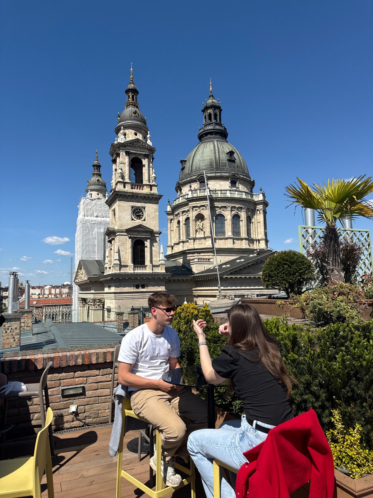 Rooftop dining scene captured overlooking Saint Stephen's Basilica Budapest