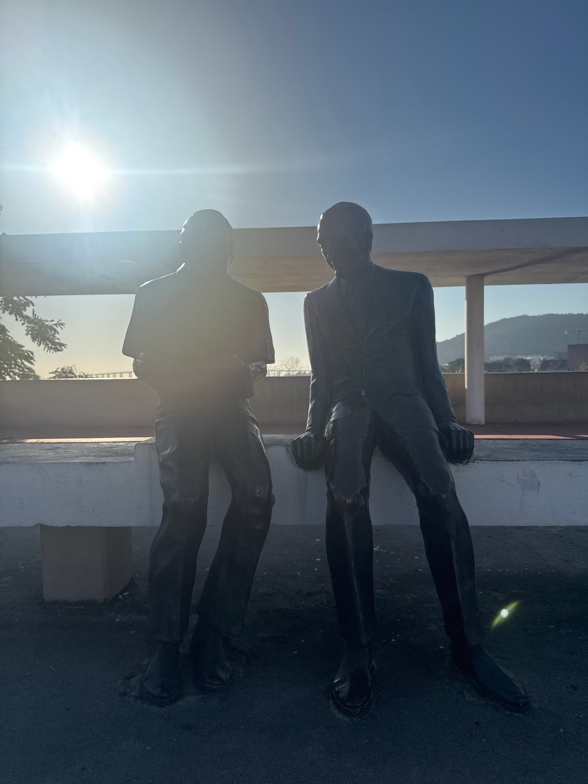Bronze bench statues and ferry crossings in Niterói