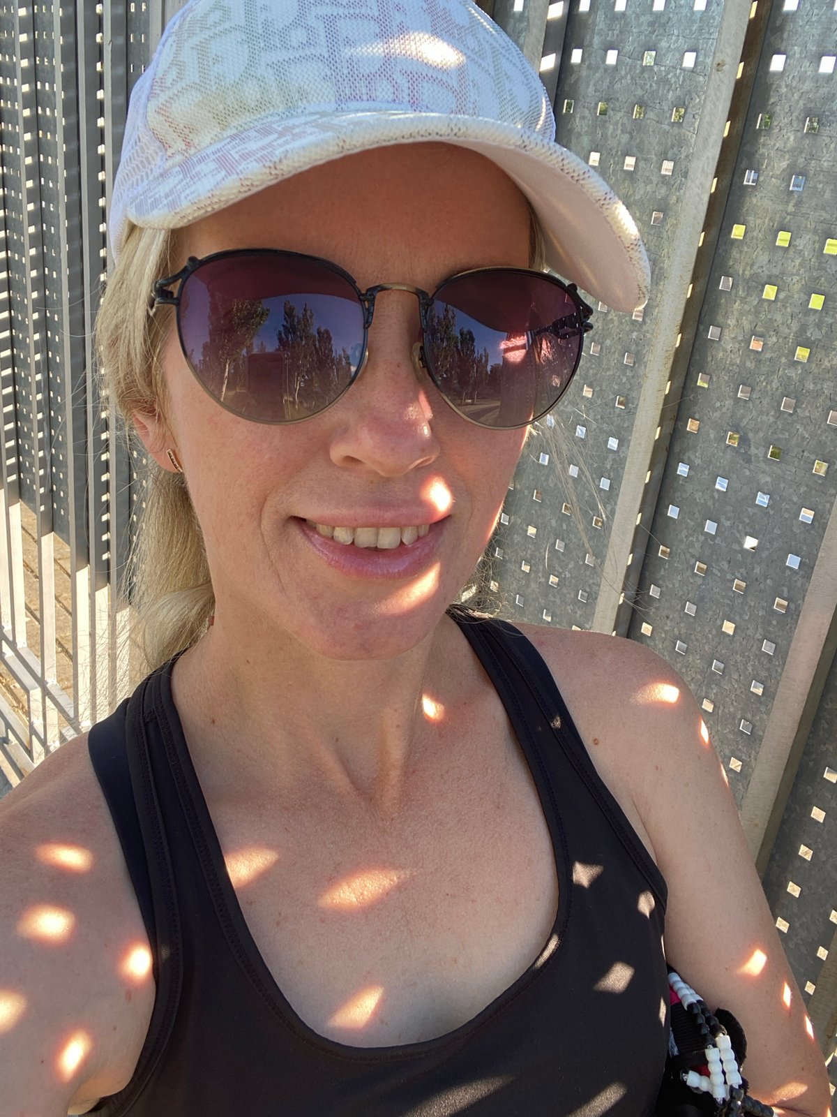 Outdoors between pink walls, sunny day, casual summer look