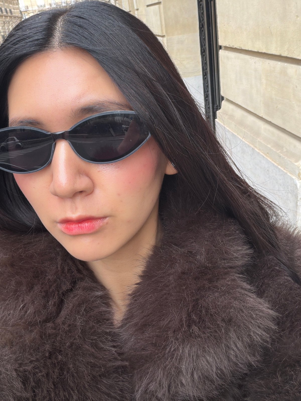 Fashion-forward individual poses for photo in Paris