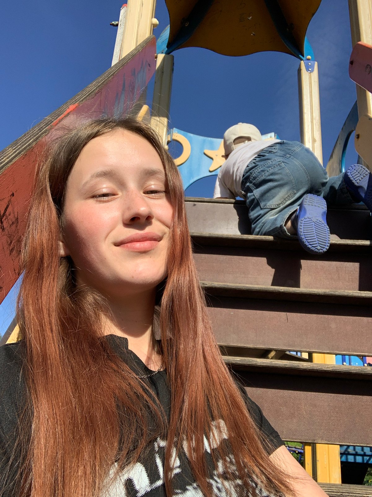Child rests on playground equipment in Russian village
