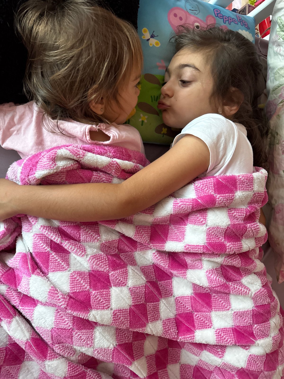 Playful moment under a checkered blanket in Oreshak