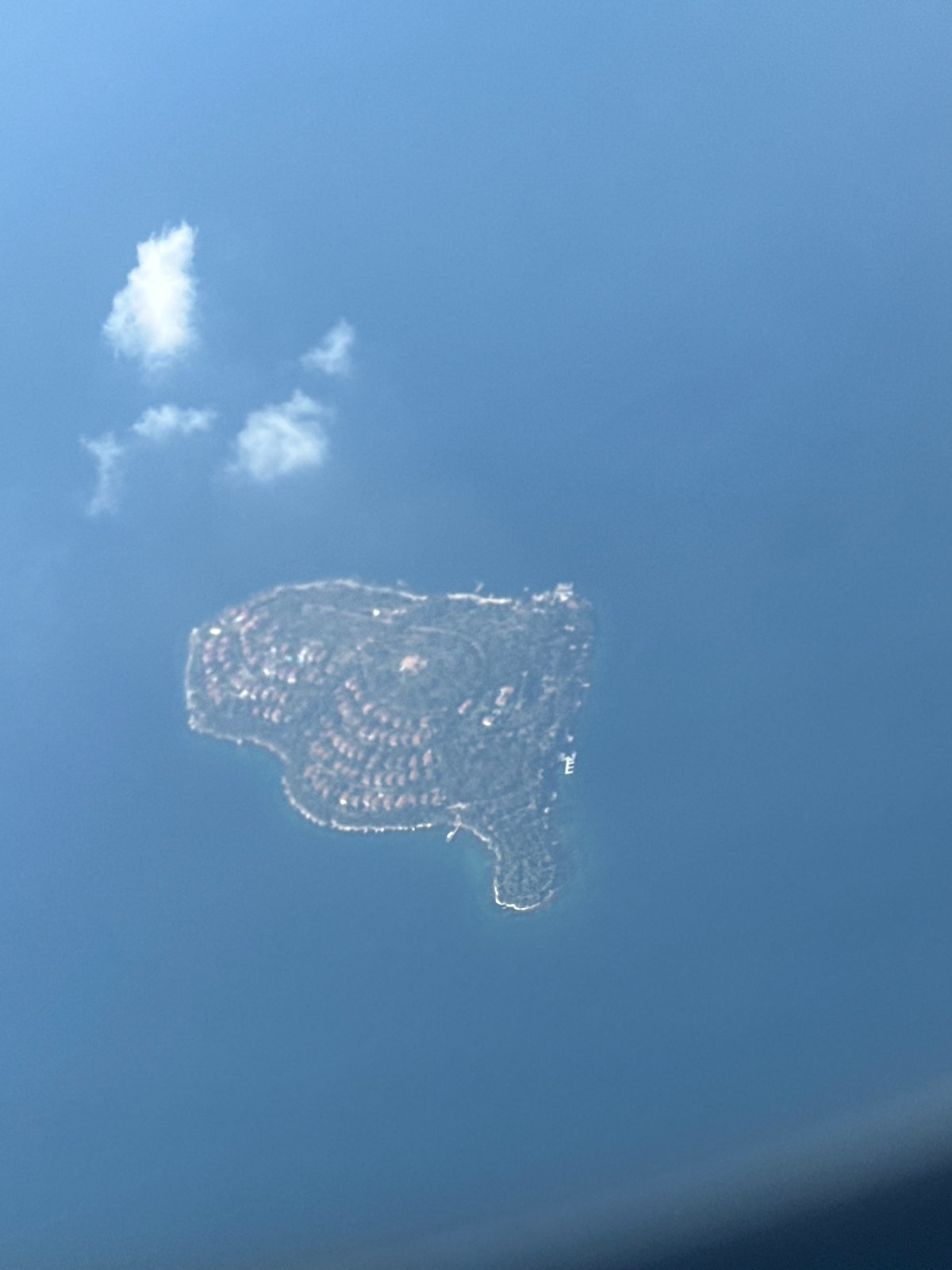 Aerial views of Marmara Sea, suspension bridge, and island from Turkish Airlines flight