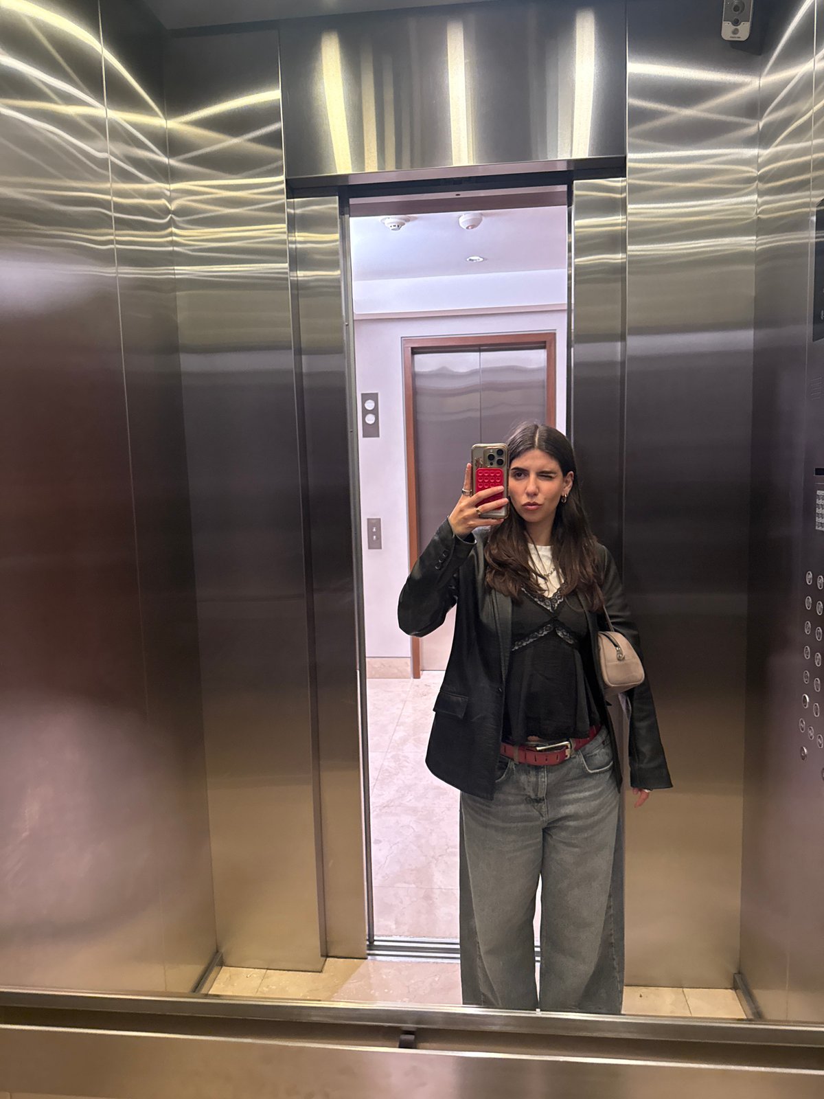 Woman takes morning selfie in Mexico City elevator