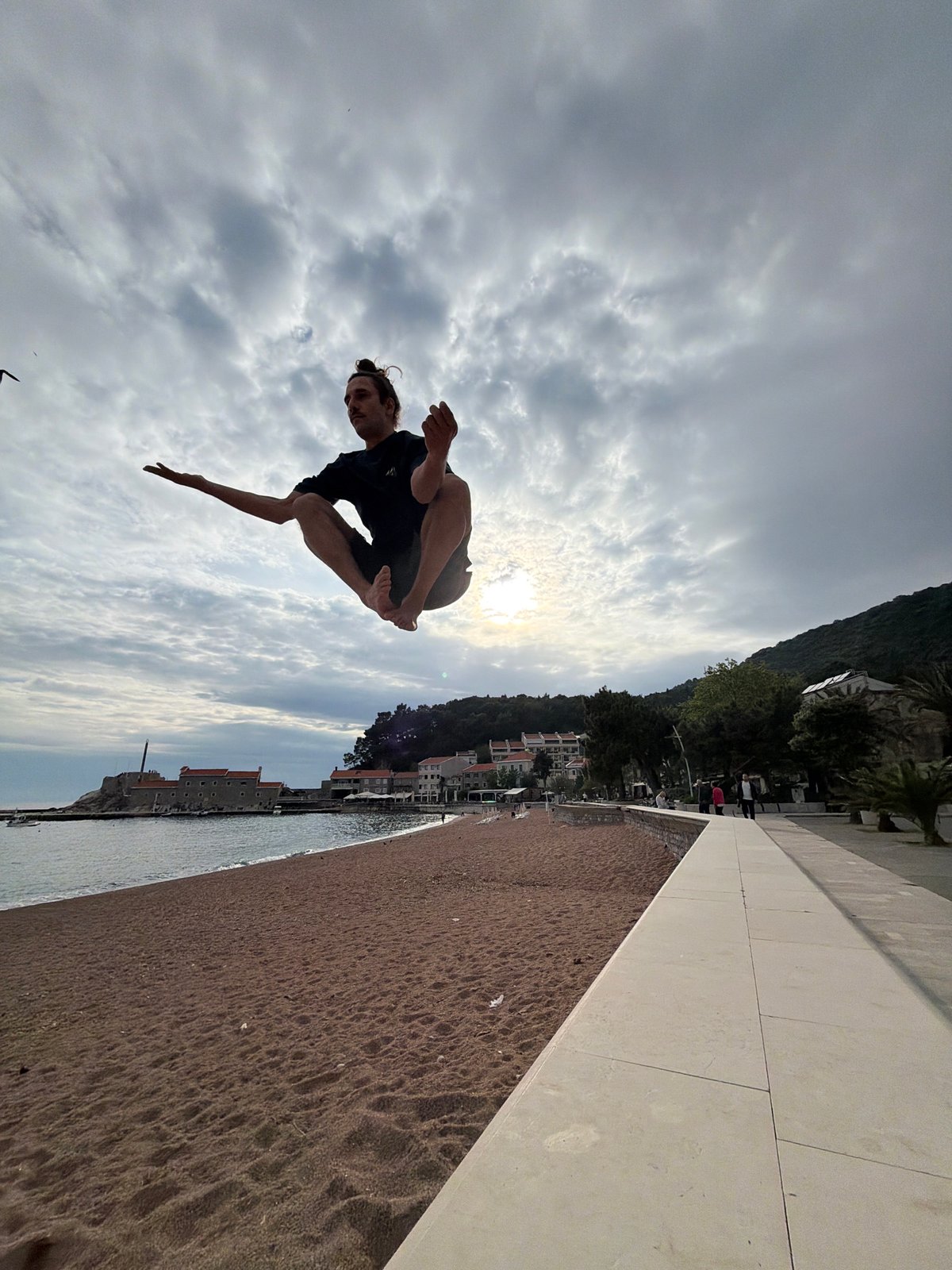 Man performs acrobatic backflips on Montenegro beach