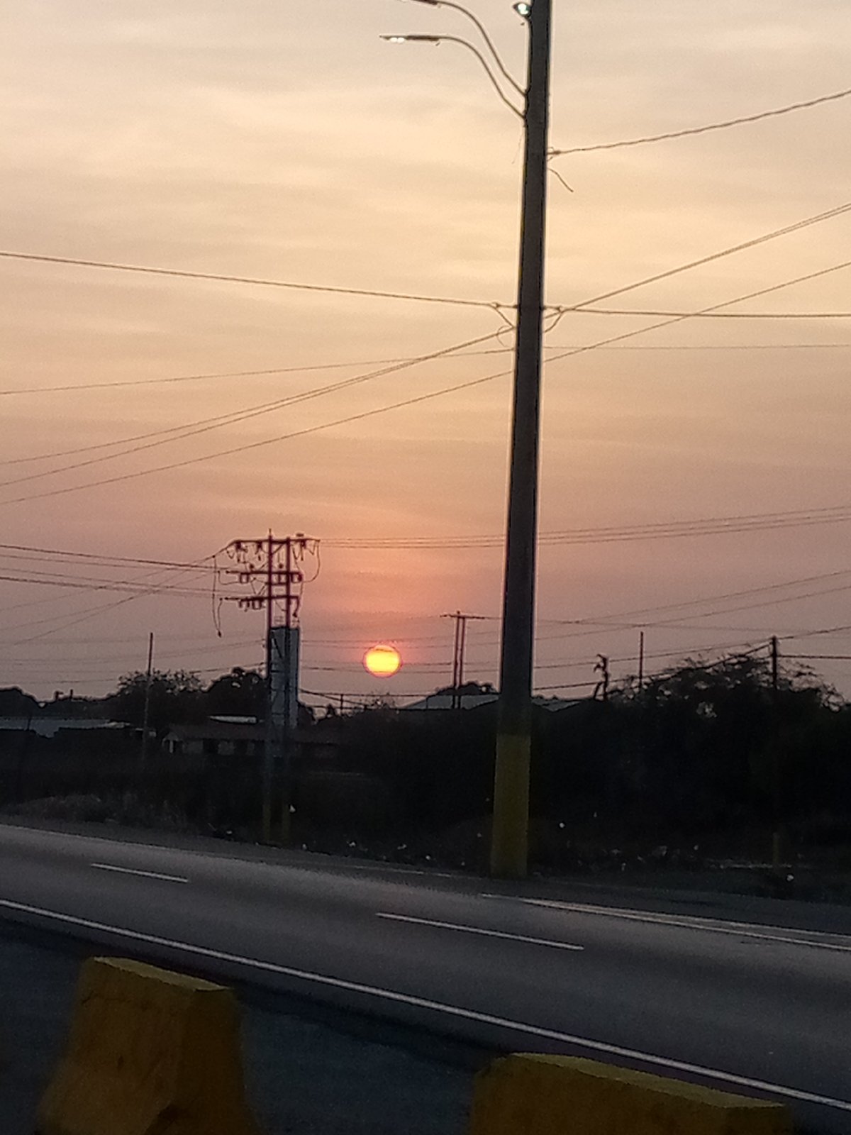 Sunset observed over roadway in El Dátil, Venezuela