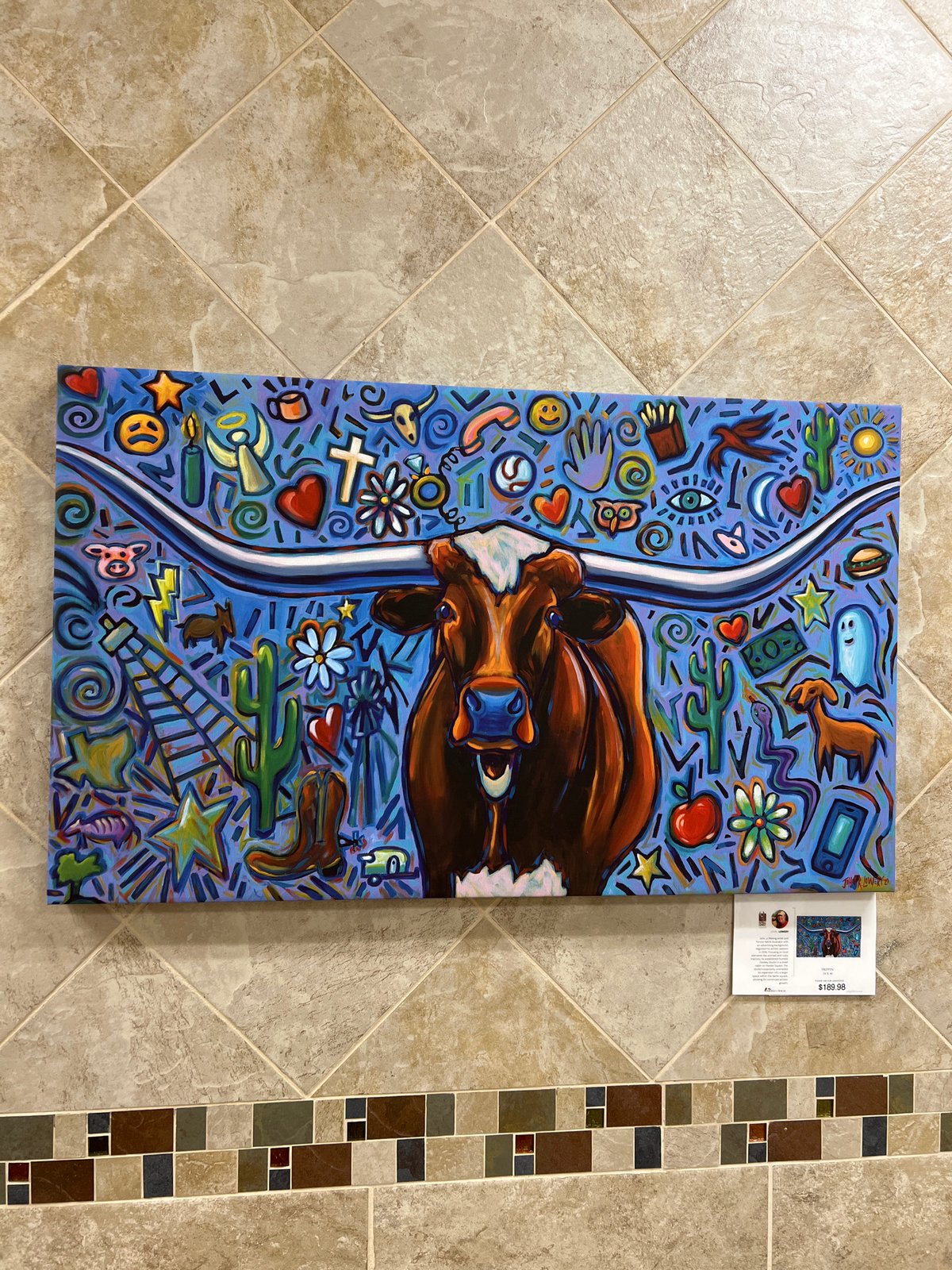 Texas Longhorn painting with bold colors and symbol-filled background