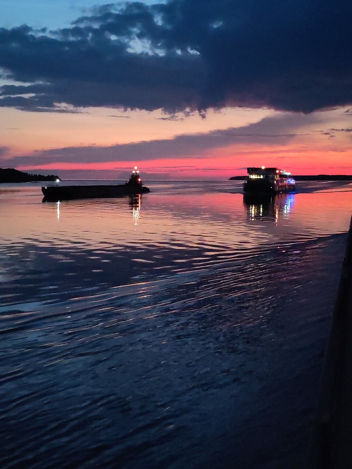 Barge at dusk on a Russian waterway, twilight sky glowing
