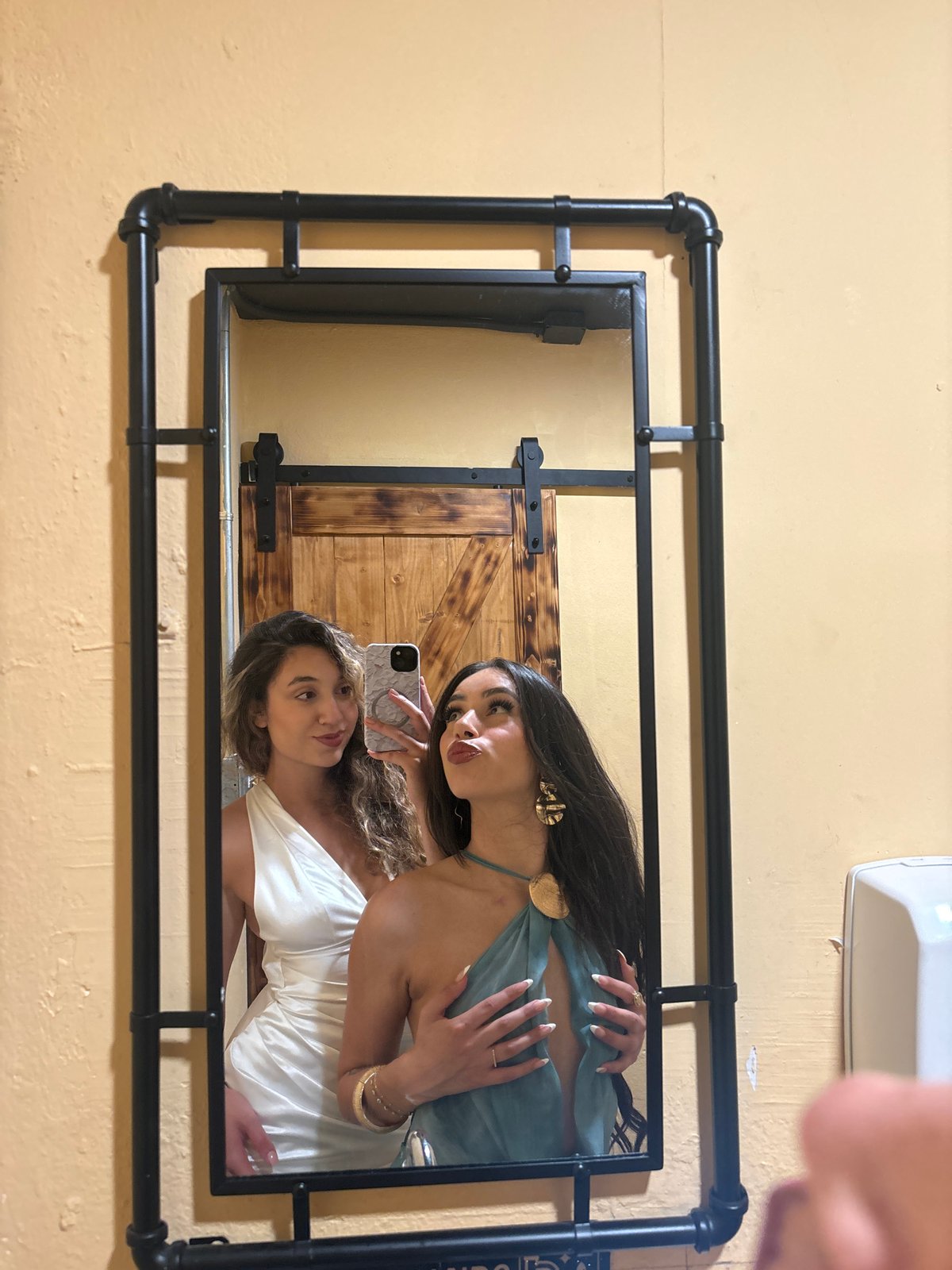 Mirror selfie moment in San Juan restroom, formal attire
