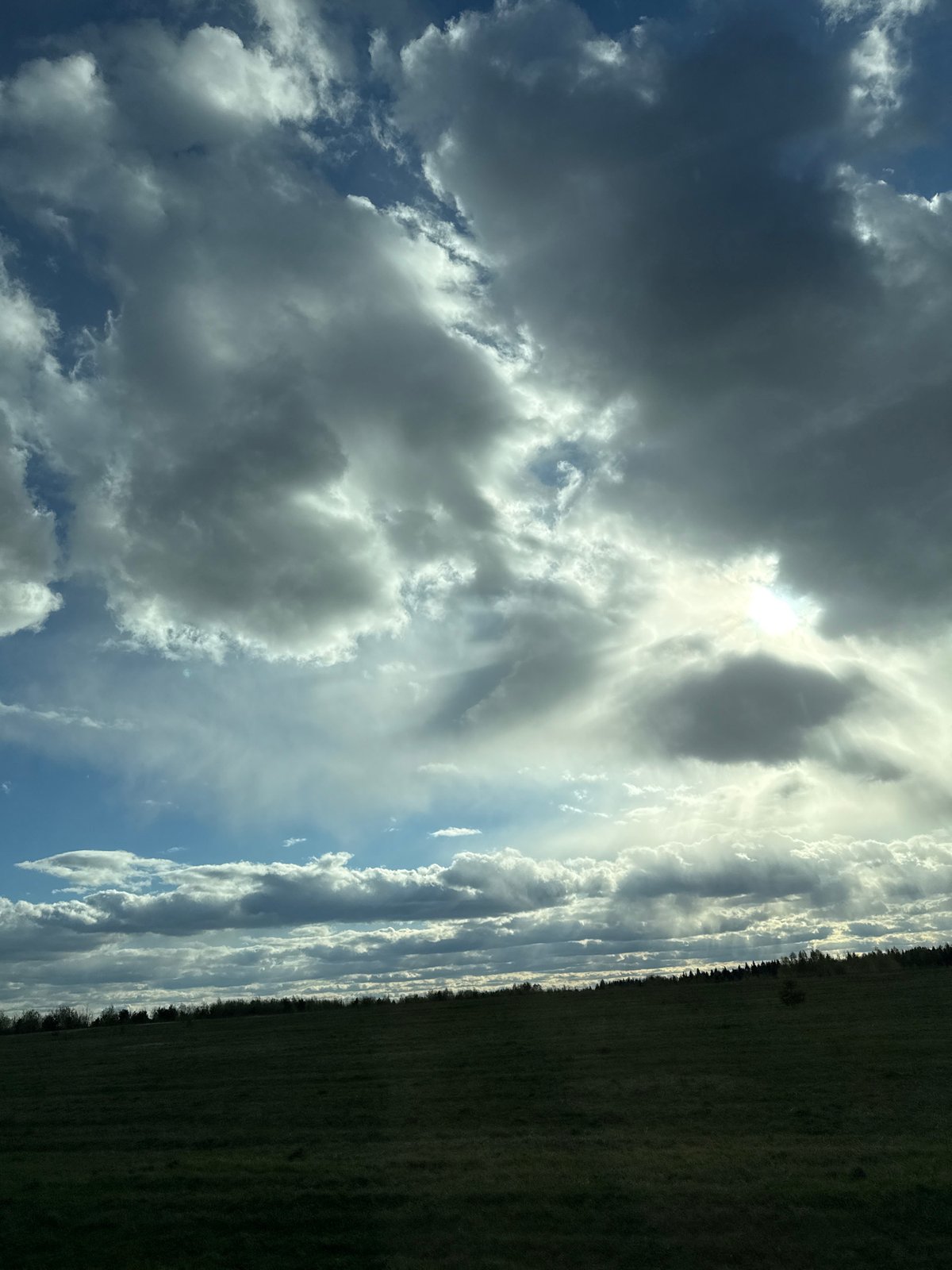 Dramatic clouds and sunlight observed over Russian countryside