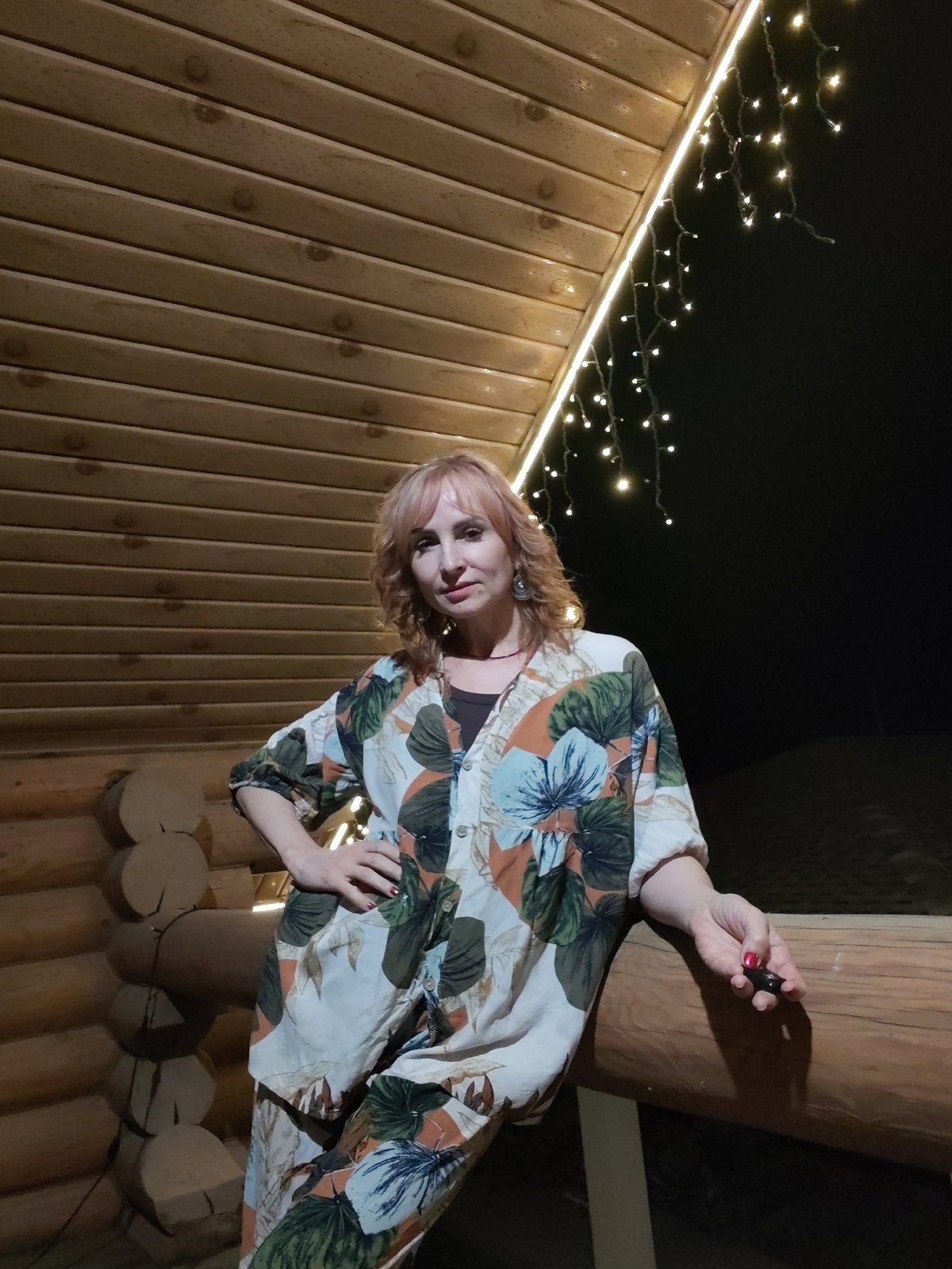 Evening social gathering documented at Russian log cabin