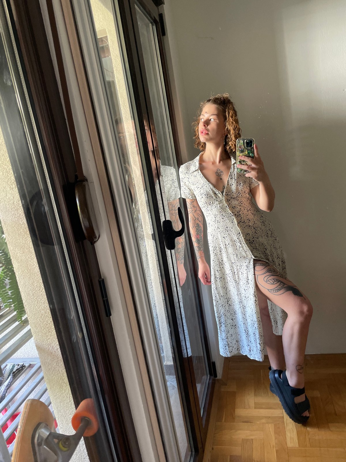 Woman takes mirror selfies with sleeping dog in Montenegro home
