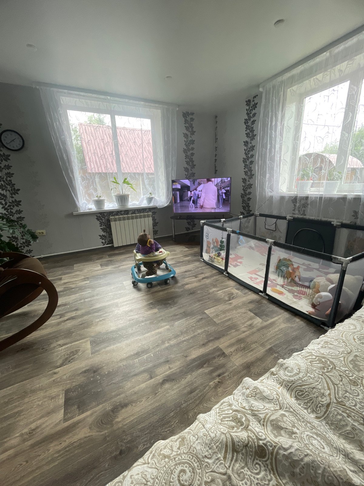 Lazy morning at home — baby in walker, pajamas, couch
