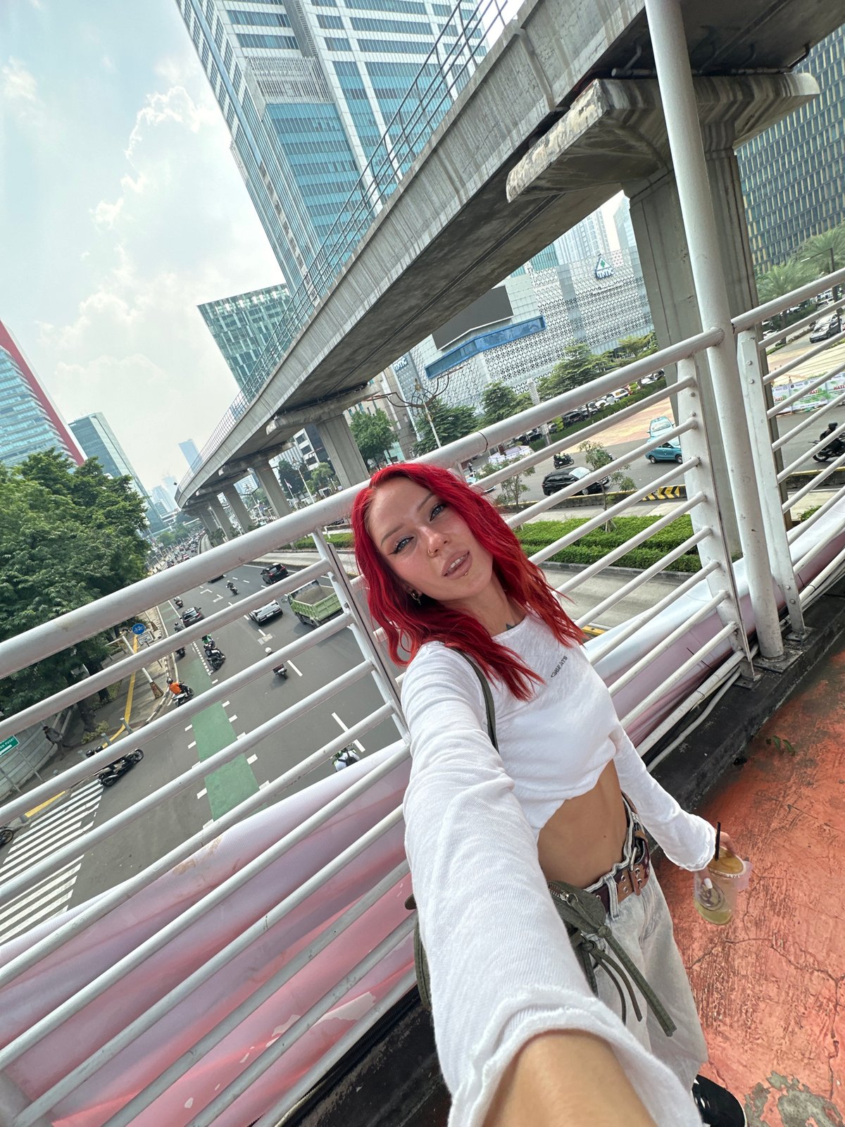 Red-haired woman takes selfies across South Jakarta locations