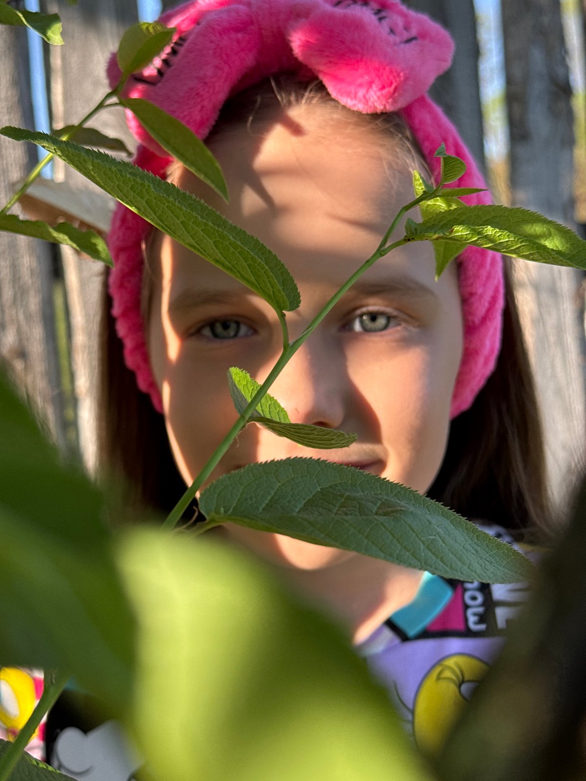 Child plays outdoors in Rusalevka during afternoon hours