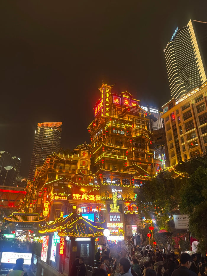 Nighttime crowds, traditional dress photography at Chongqing's Hongyadong complex