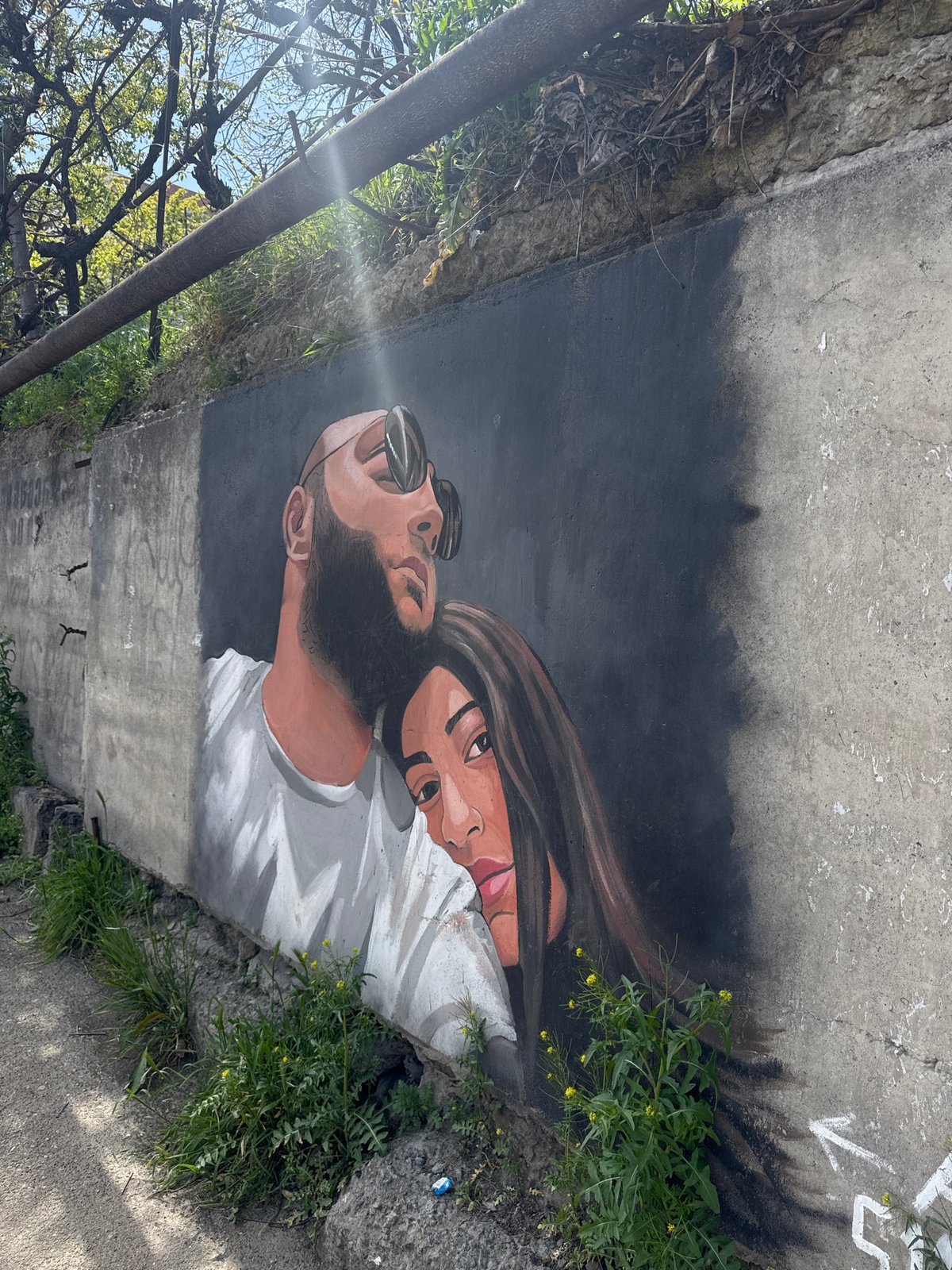 Portrait mural of two people documented in Tbilisi