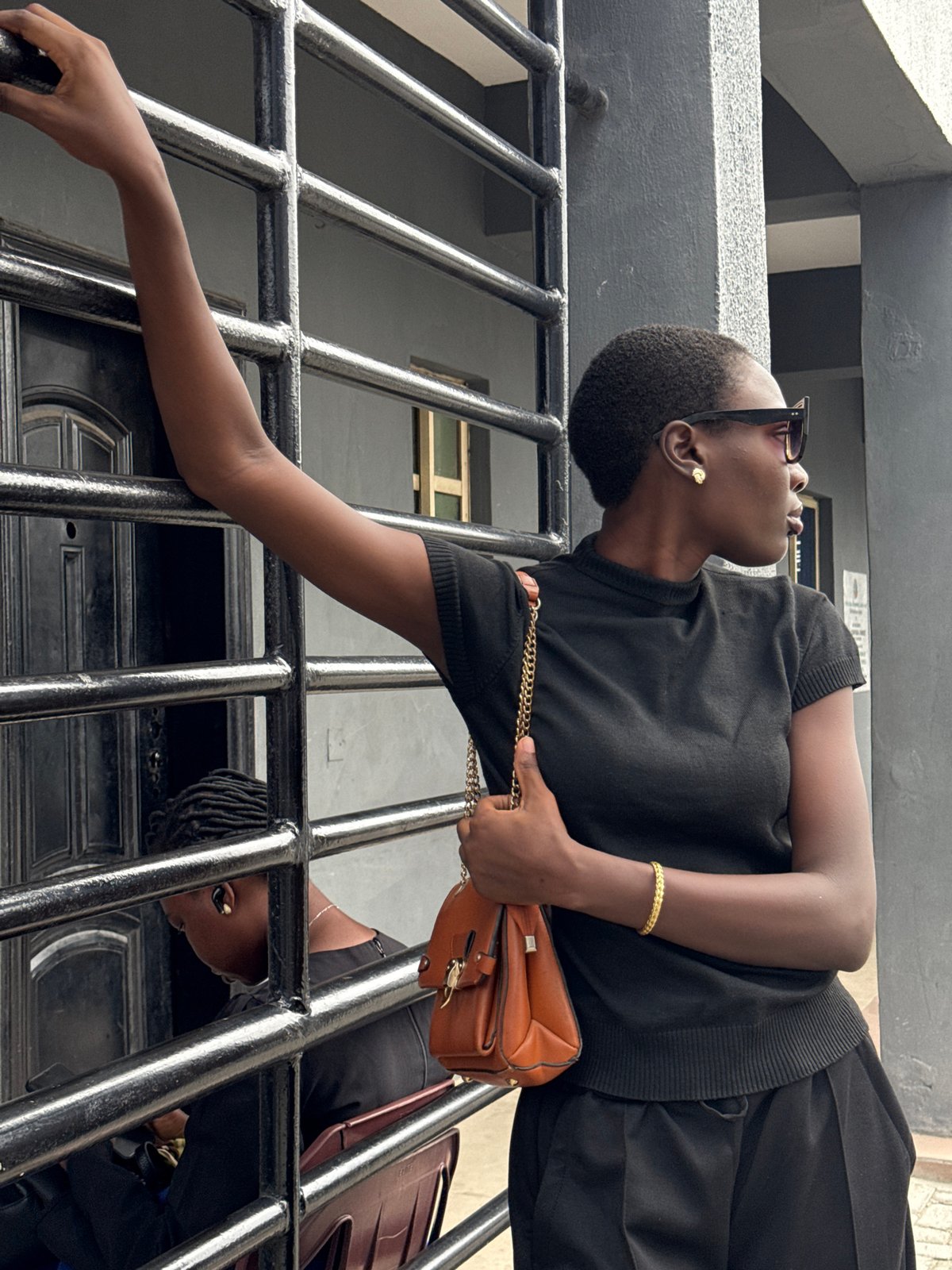 Woman in black observed at gate in Ojomu, Nigeria