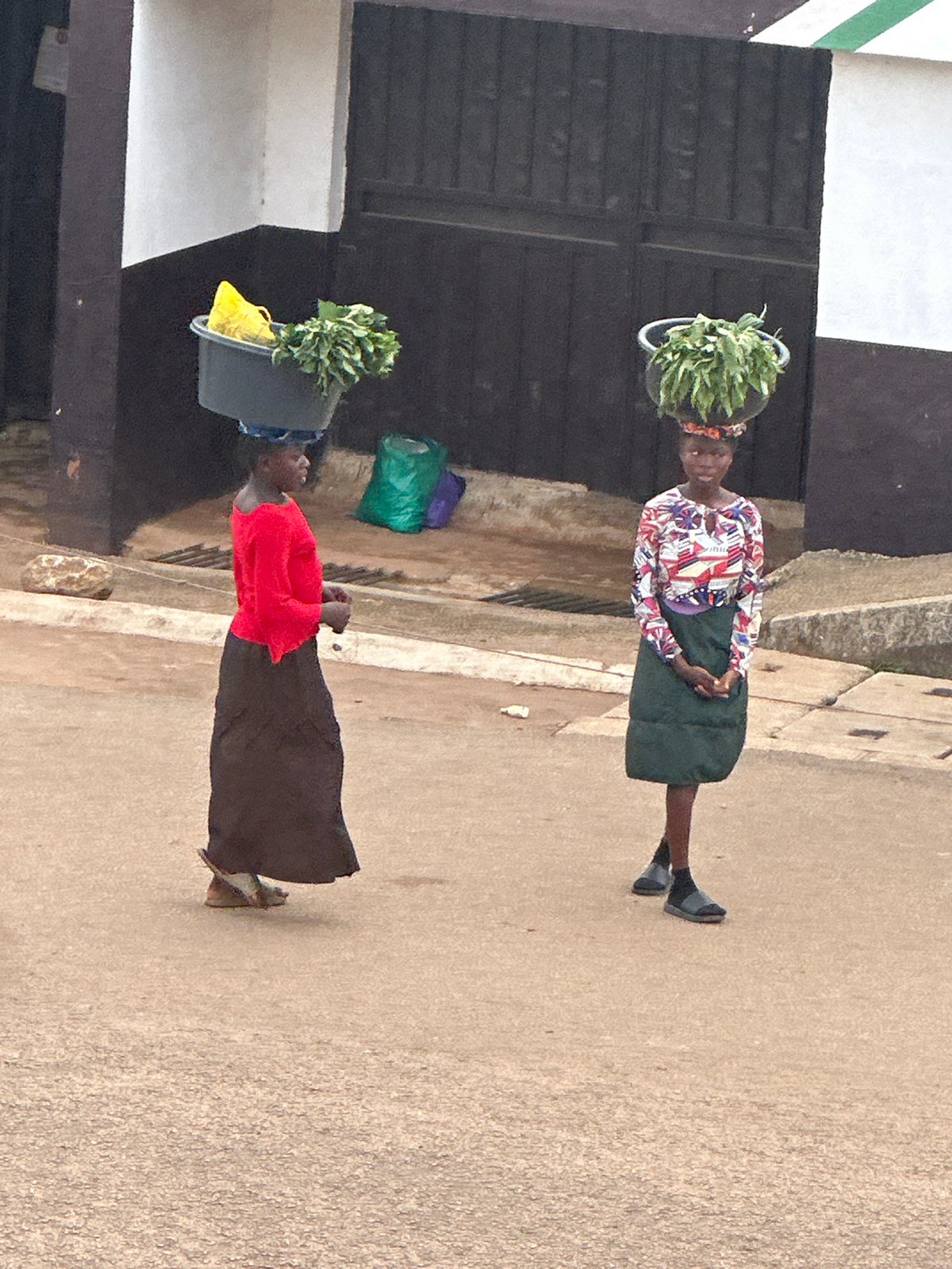 Afternoon street life along Bukuru's busy commercial corridor