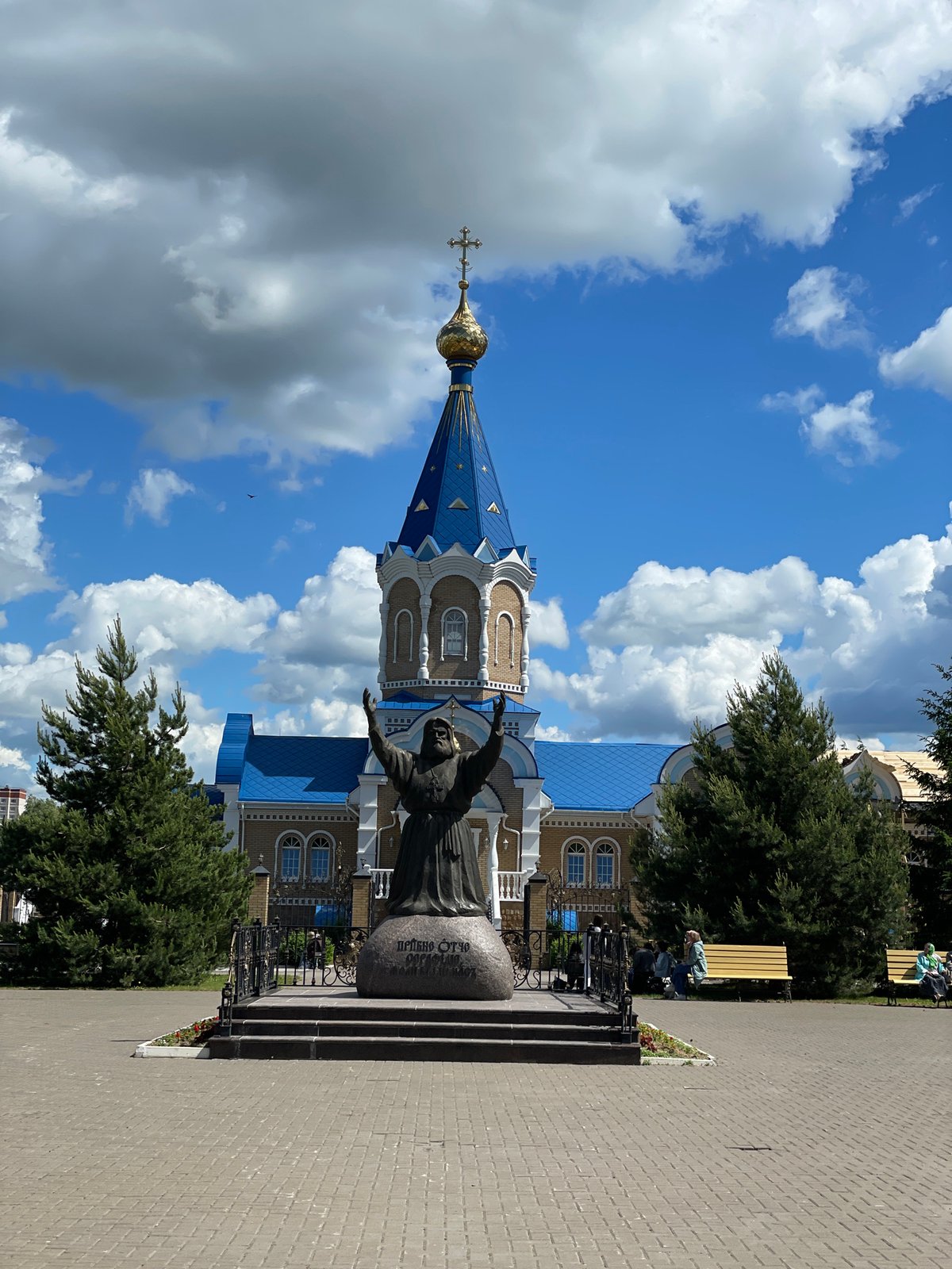 Mother and child visit church in Izhevsk on sunny morning