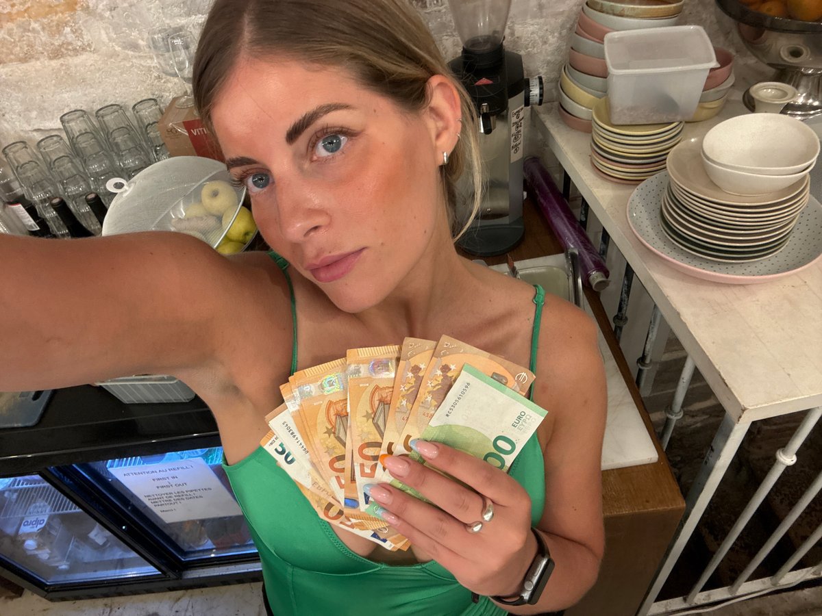 Euro cash fanned out near a Paris café register