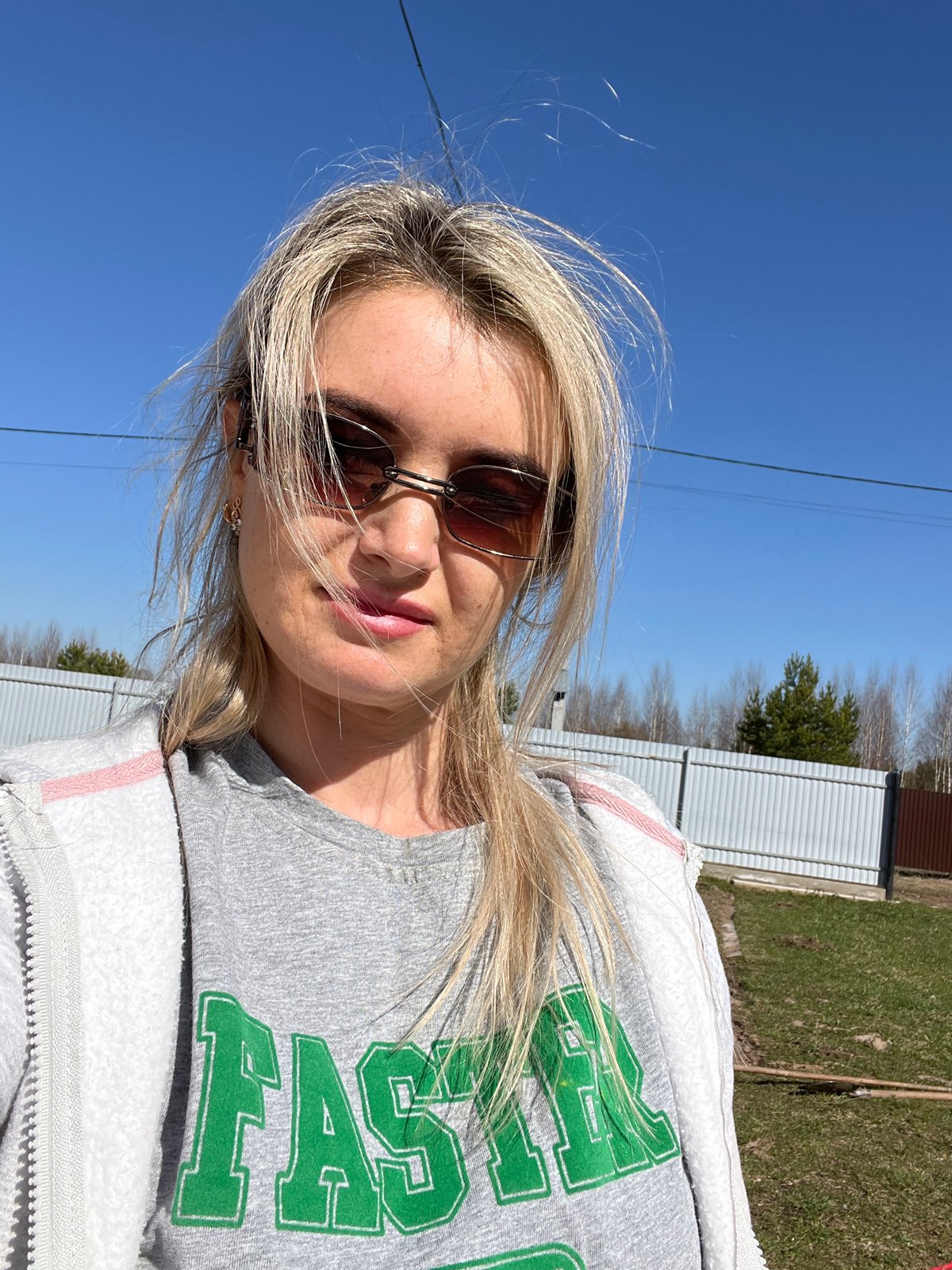 Woman takes selfie near outdoor grill in Гаревая, Russia