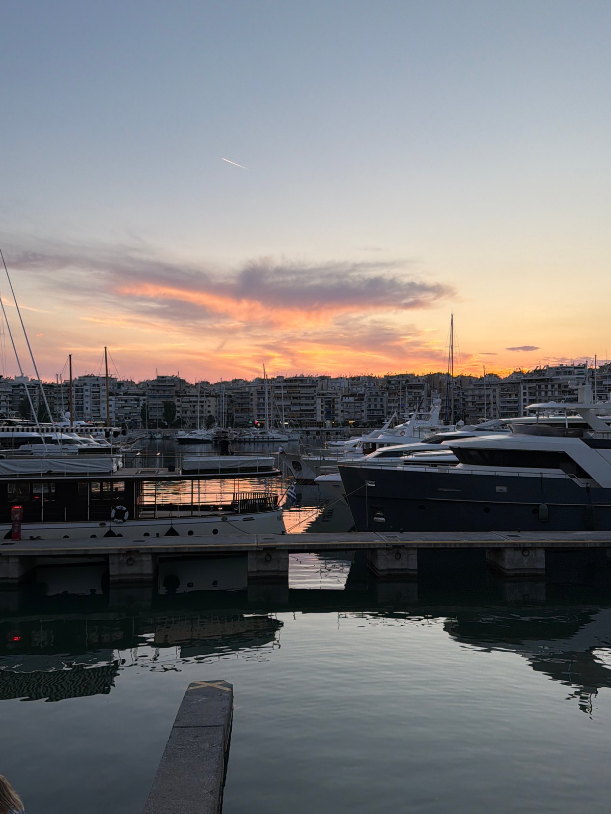 Evening sunset captured at Piraeus harbor with dining and street life
