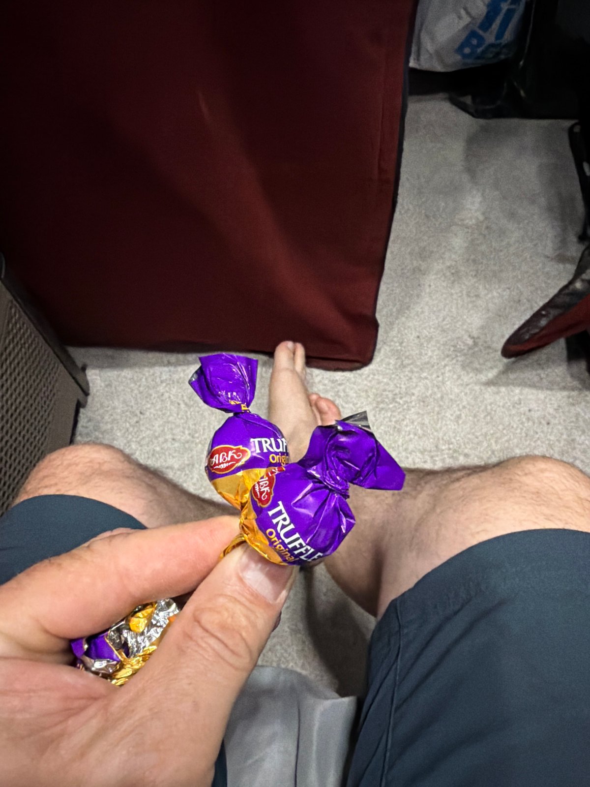 Person enjoys Truffle Original candies in early morning Elgin