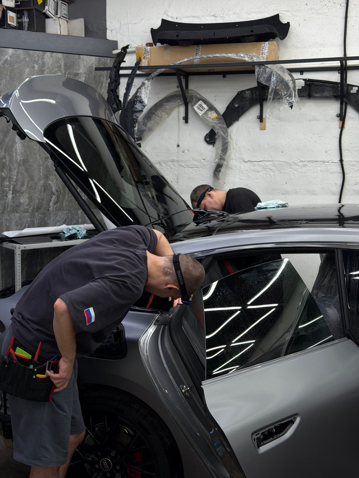 Men repair car in Krasnoyarsk garage