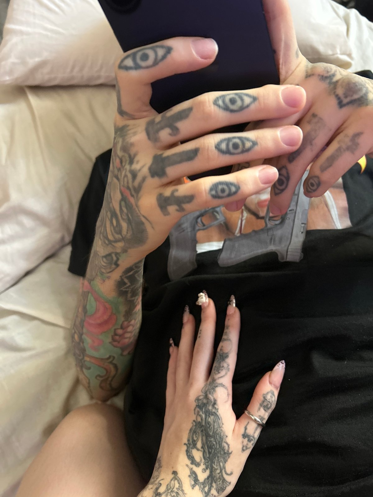 Intimate moment captured between tattooed individuals in Buenos Aires bedroom