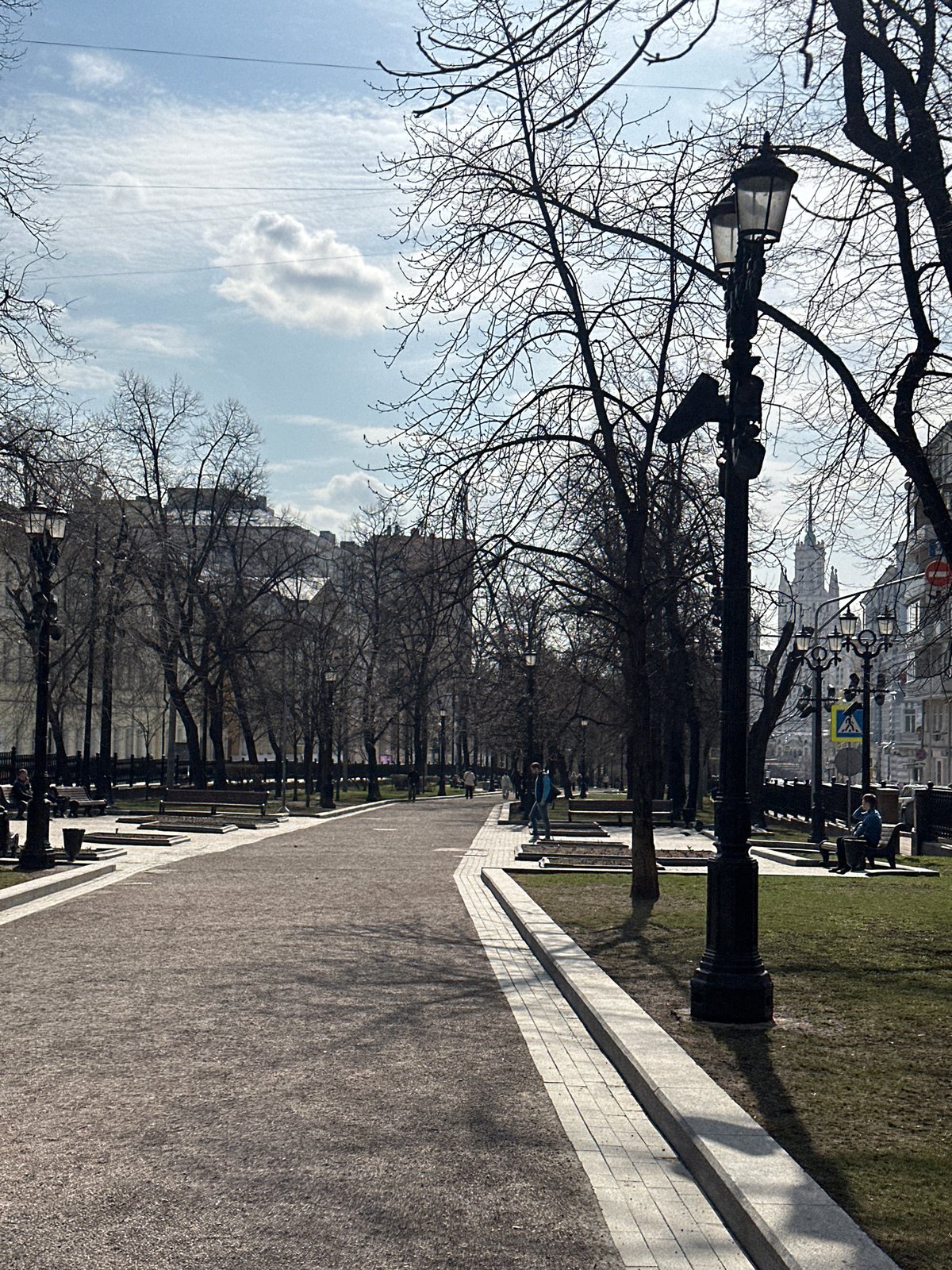 Moscow park walkway documented amid bare spring trees