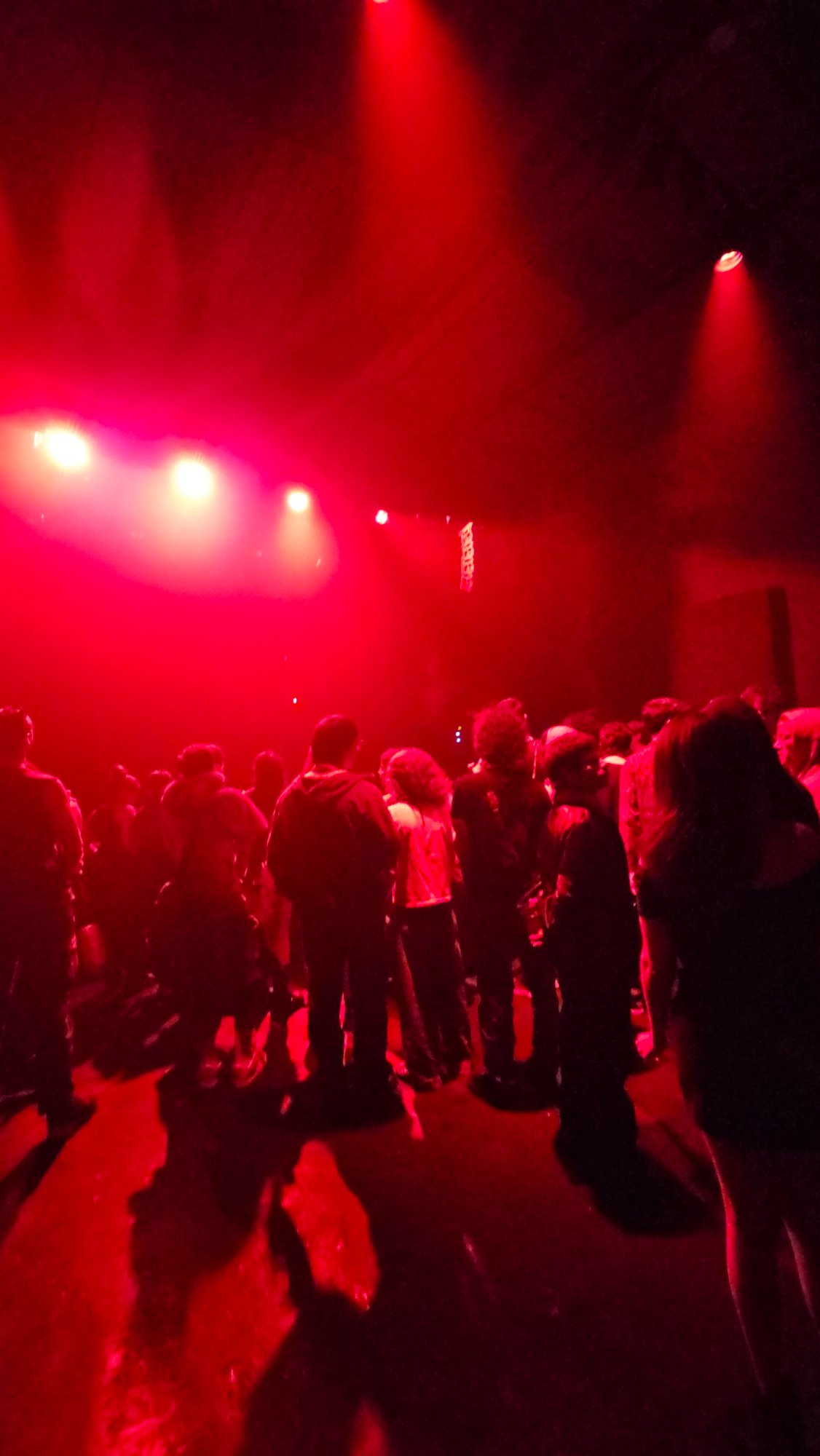 Dense crowd gathered under red stage lights in Buenos Aires