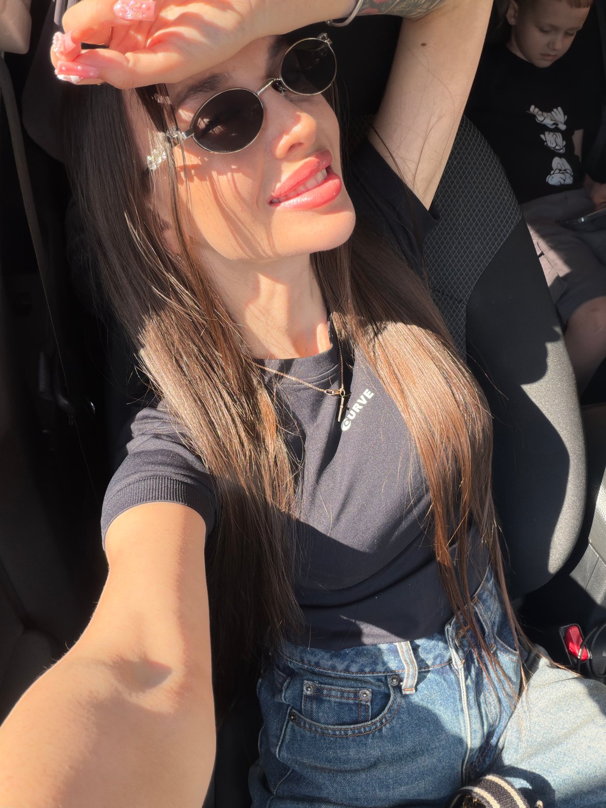 Woman and child photographed during sunny car ride in Izhevsk