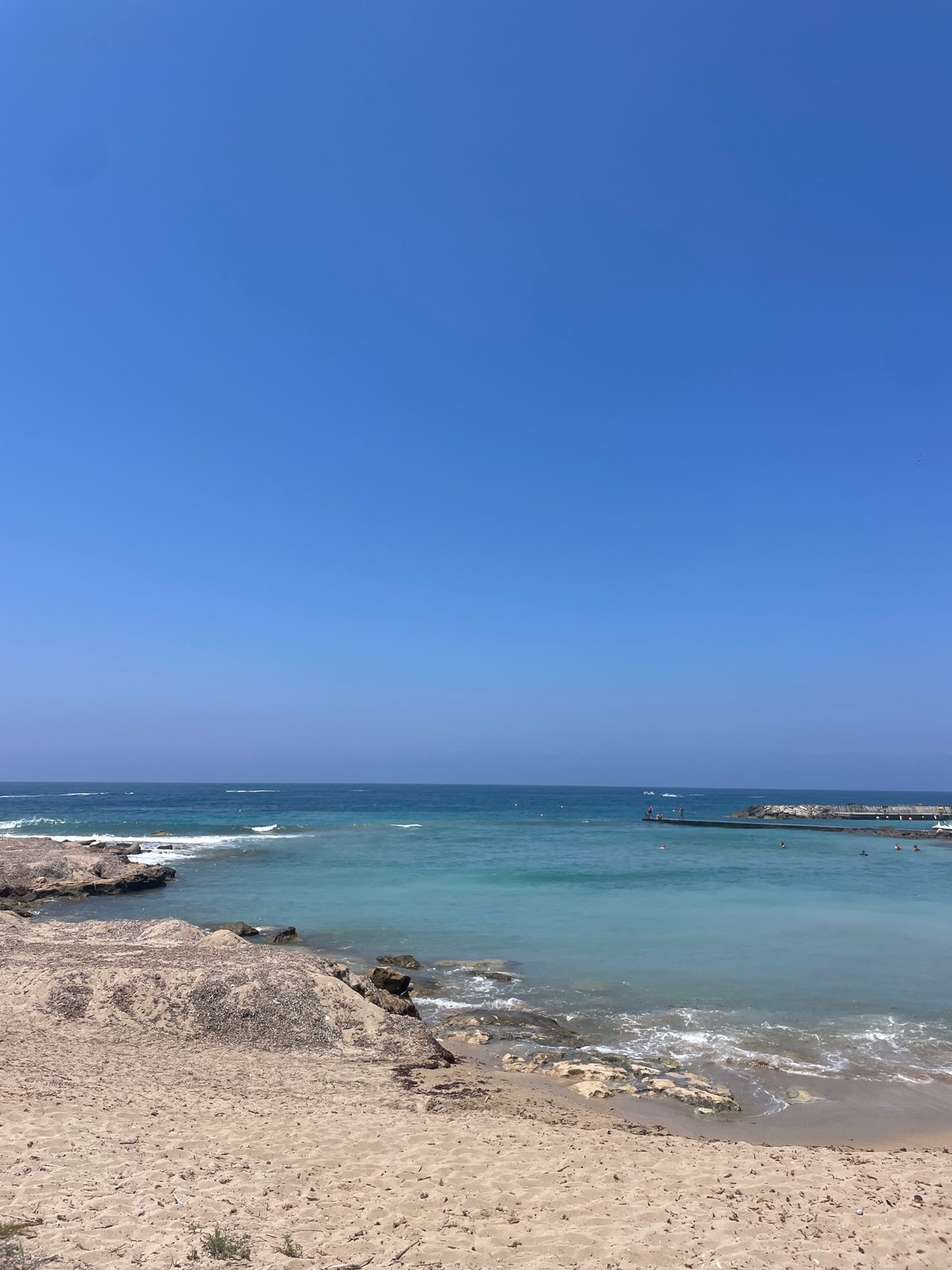 Sunny morning at a Paphos beach, Mediterranean shore in focus