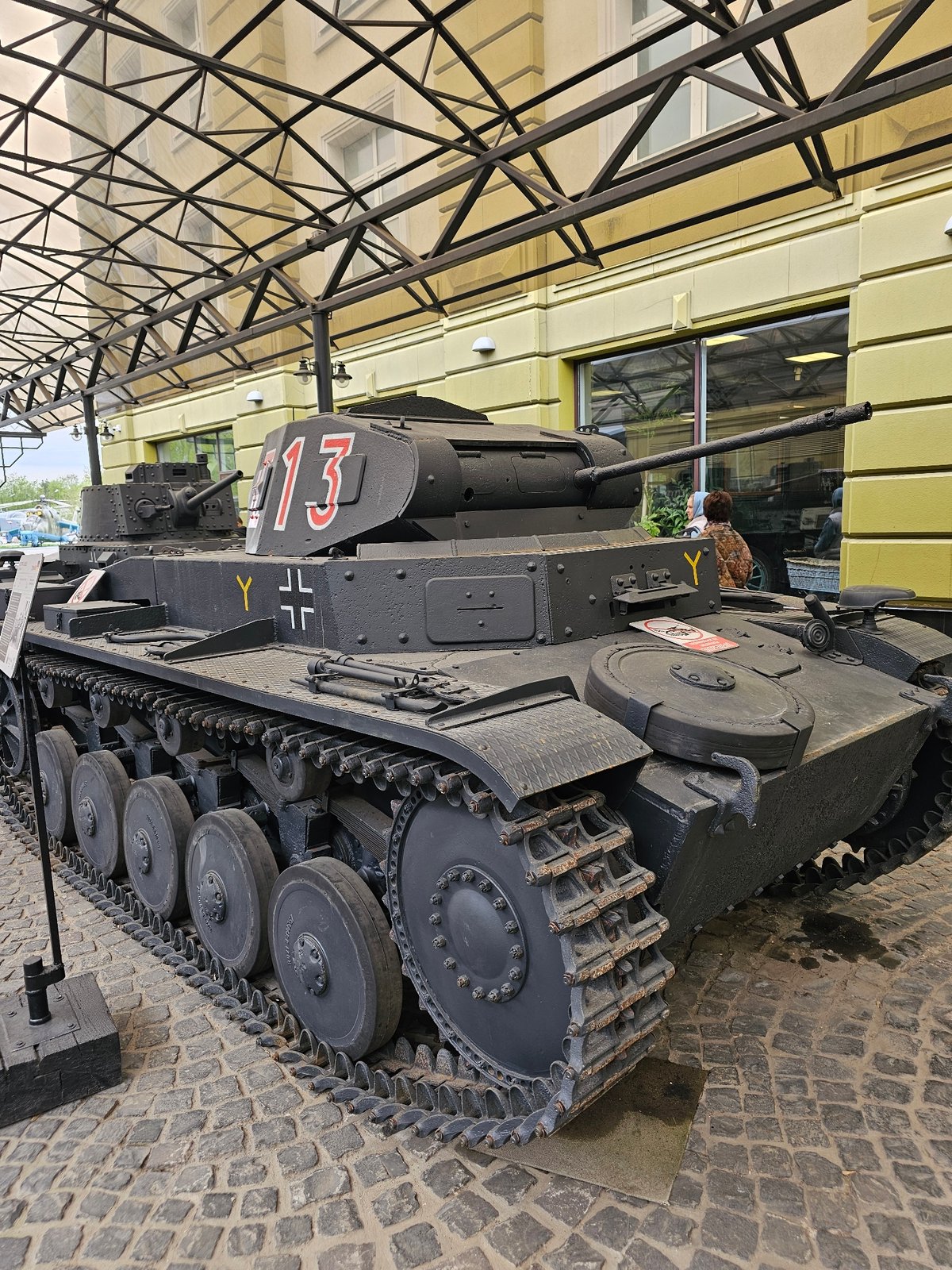 Child explores vintage military vehicle display in Arkhangel'skoye museum