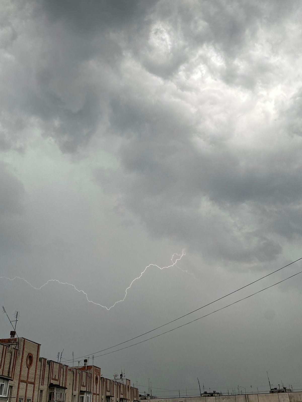 Lightning storm strikes urban area during afternoon thunderstorm