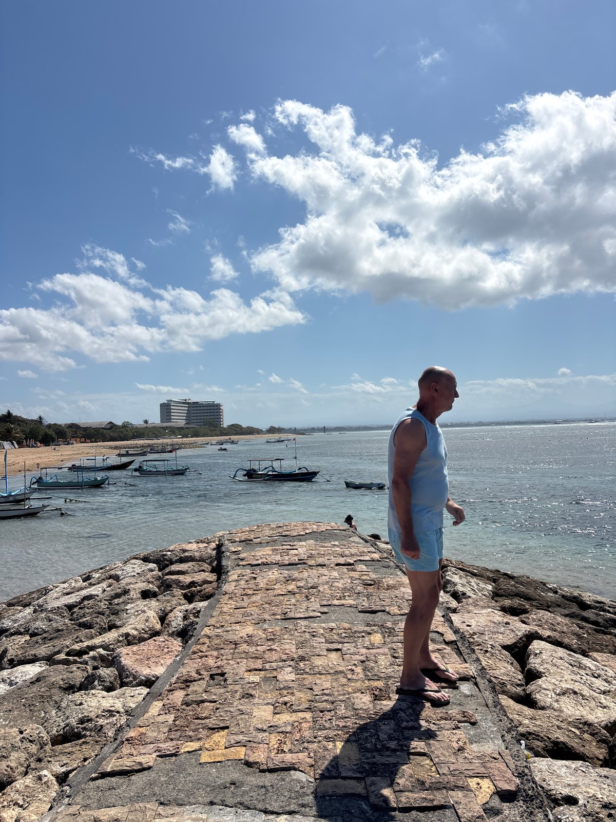 Sunny morning stroll along Denpasar's stone beachfront walkway