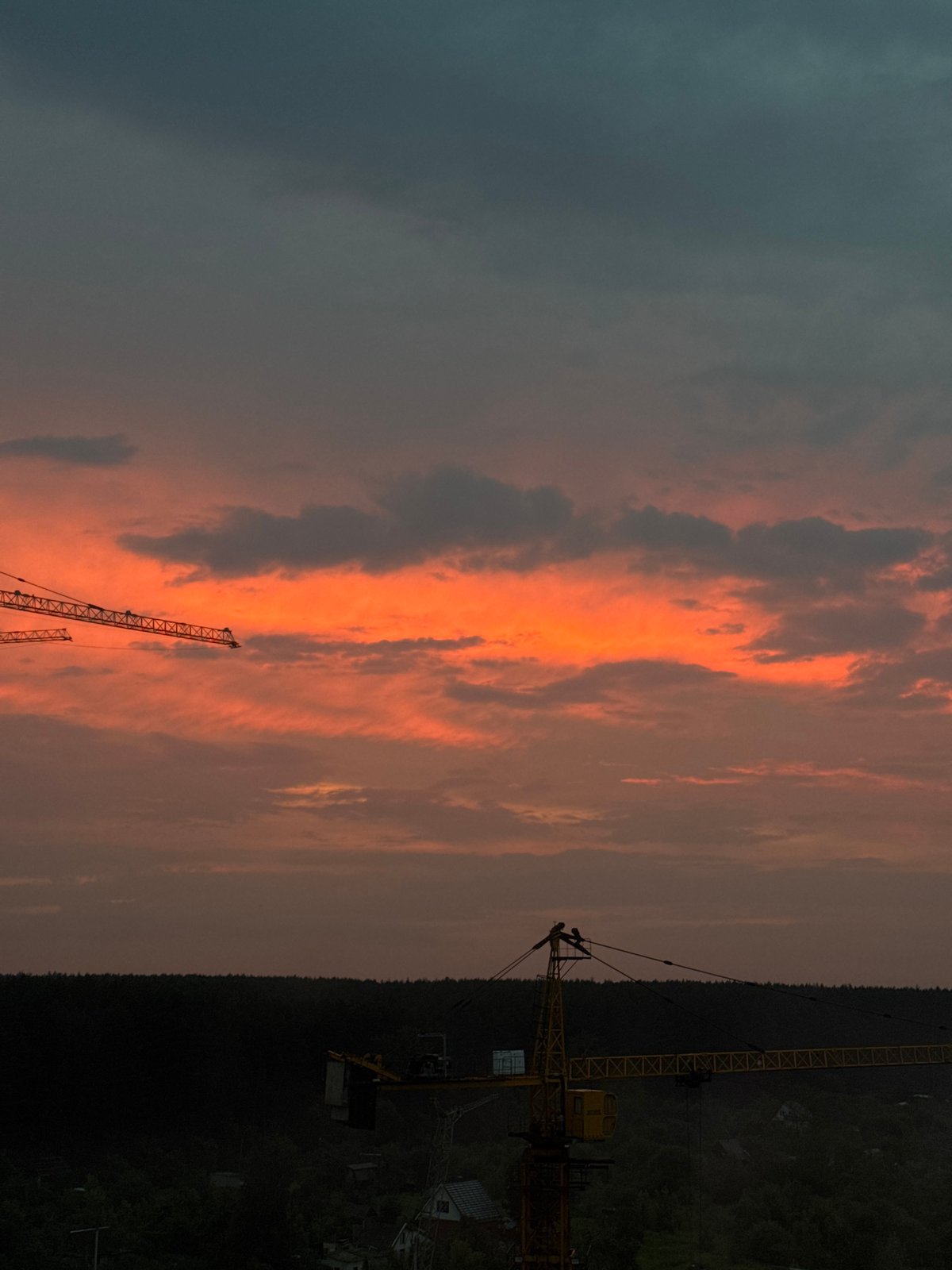 Cranes and apartment towers at sunset in Izhevsk
