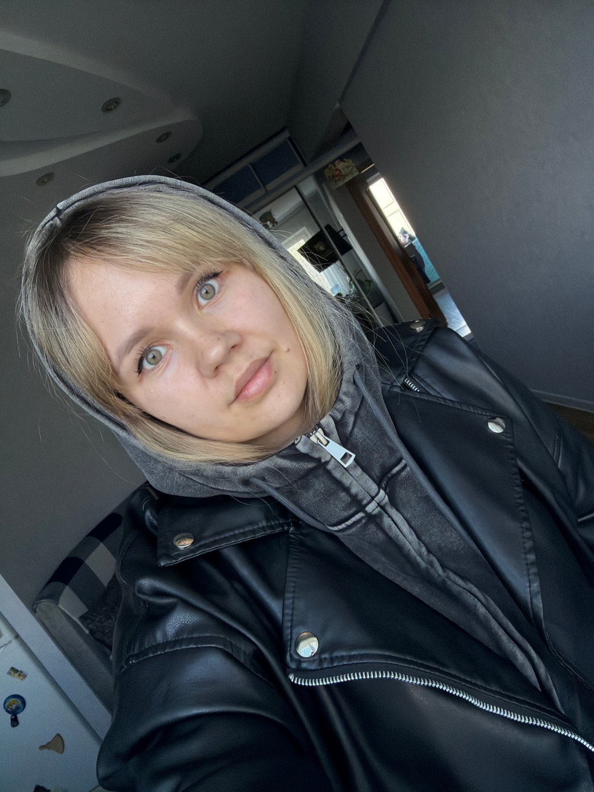 Young woman documents morning with series of indoor selfies