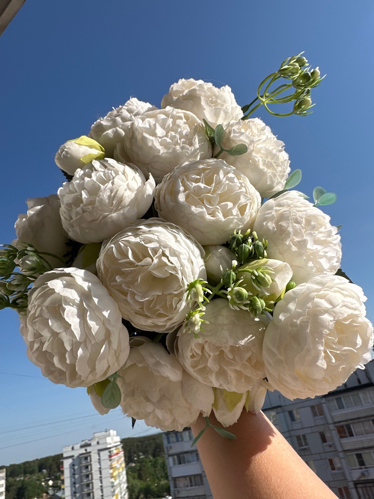 Woman photographed with white flowers in Chaikovsky, Russia