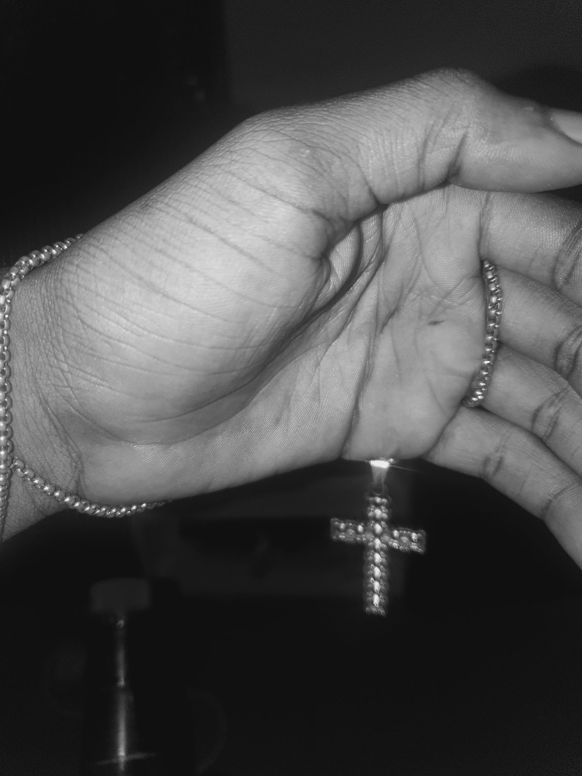 Individual photographed with jewelry and whisky in Lokoja room