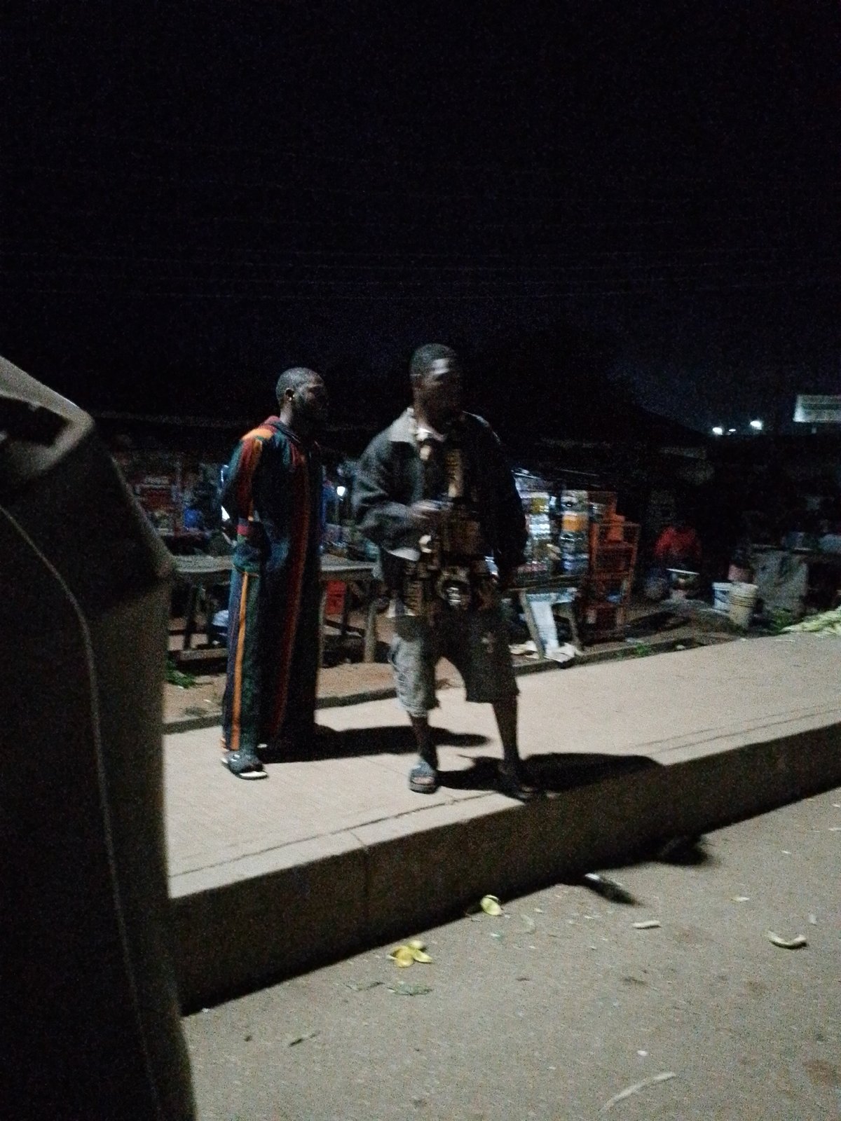 Late night street life around Bukuru's keke napep stands and corn vendors