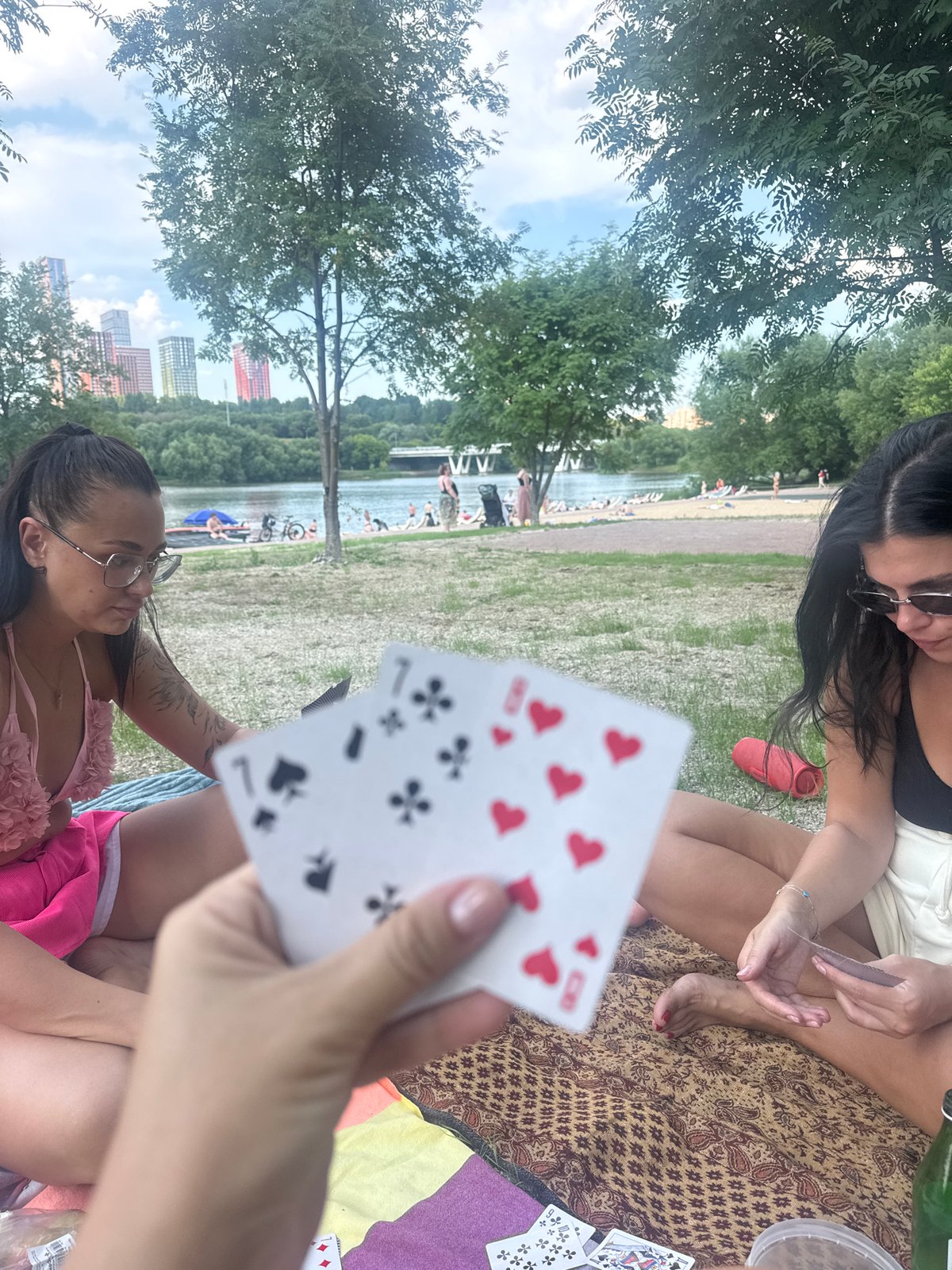 Card game on the grass by a Moscow riverbank