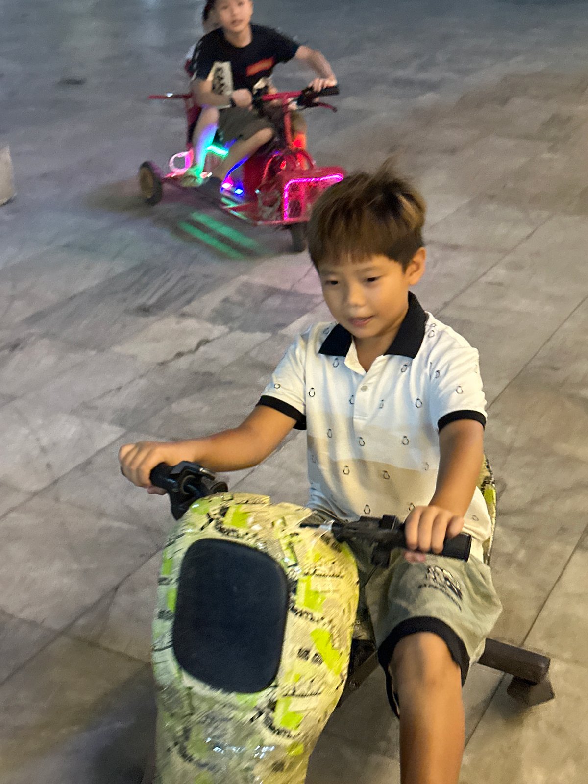 Vietnamese families enjoy evening festival with illuminated rides